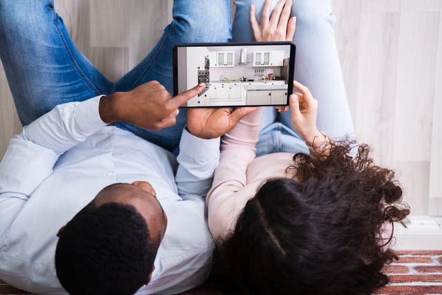 Couple looking at new kitchen ideas on a tablet