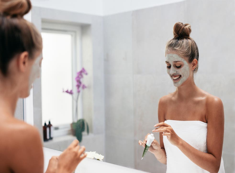 woman applying facemask