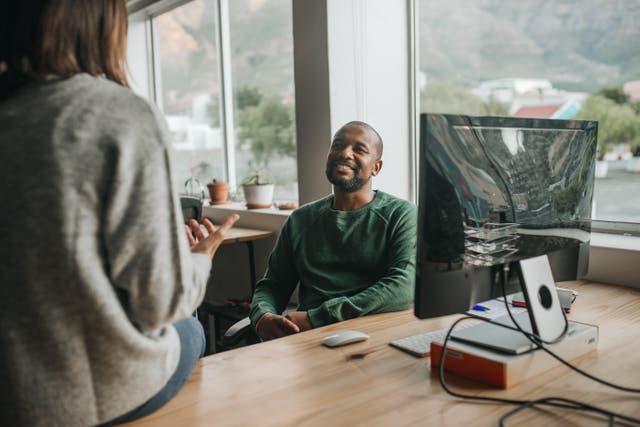 Man taking a break from work and talking to a colleague