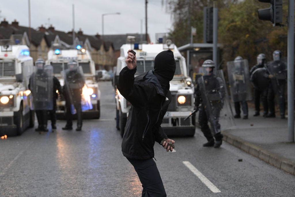 A nationalist attacks police on Springfield Road, near the Peace Wall gates dividing nationalist and loyalist communities, on 8 April