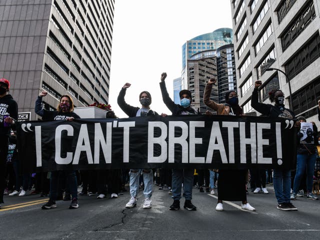 <p>In this file photo demonstrators hold a banner during the I Cant Breathe - Silent March for Justice in front of the Hennepin County Government Centre on 7 March 2021</p>