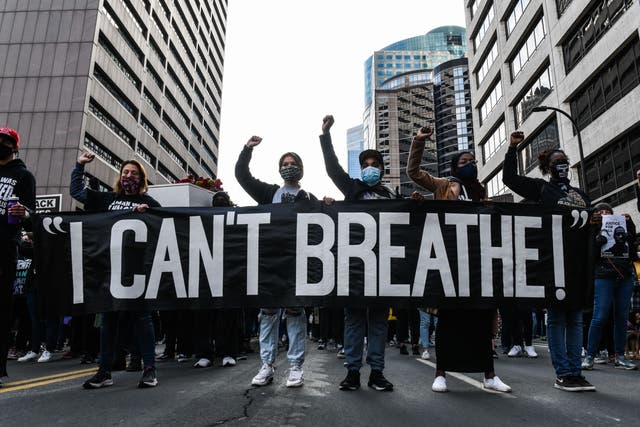 <p>In this file photo demonstrators hold a banner during the I Cant Breathe - Silent March for Justice in front of the Hennepin County Government Centre on 7 March 2021</p>