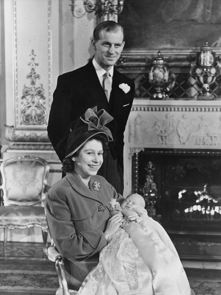 15 December 1948: Princess Elizabeth and The Prince Philip, Duke of Edinburgh with Prince Charles after his christening at Buckingham Palace.