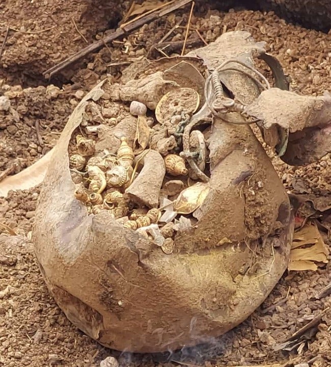 The copper pot found buried in the plot contained gold and silver earrings, necklace and beads