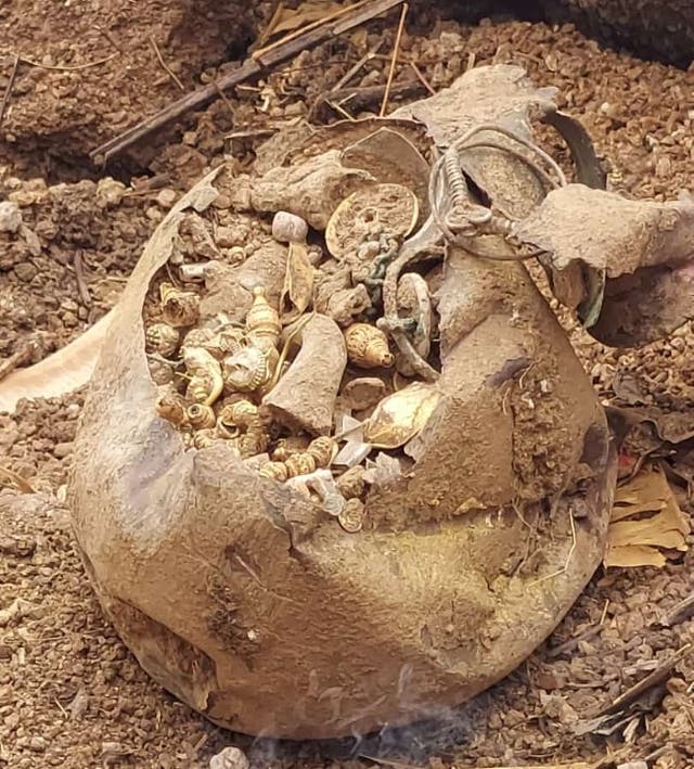 <p>The copper pot found buried in the plot contained gold and silver earrings, necklace and beads</p>
