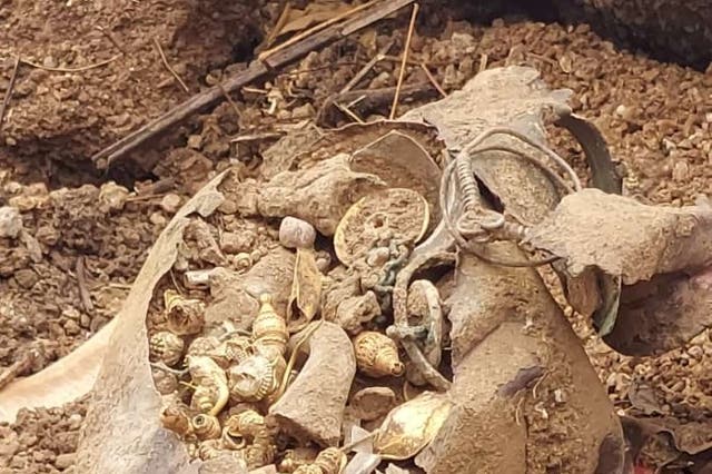 <p>The copper pot found buried in the plot contained gold and silver earrings, necklace and beads</p>
