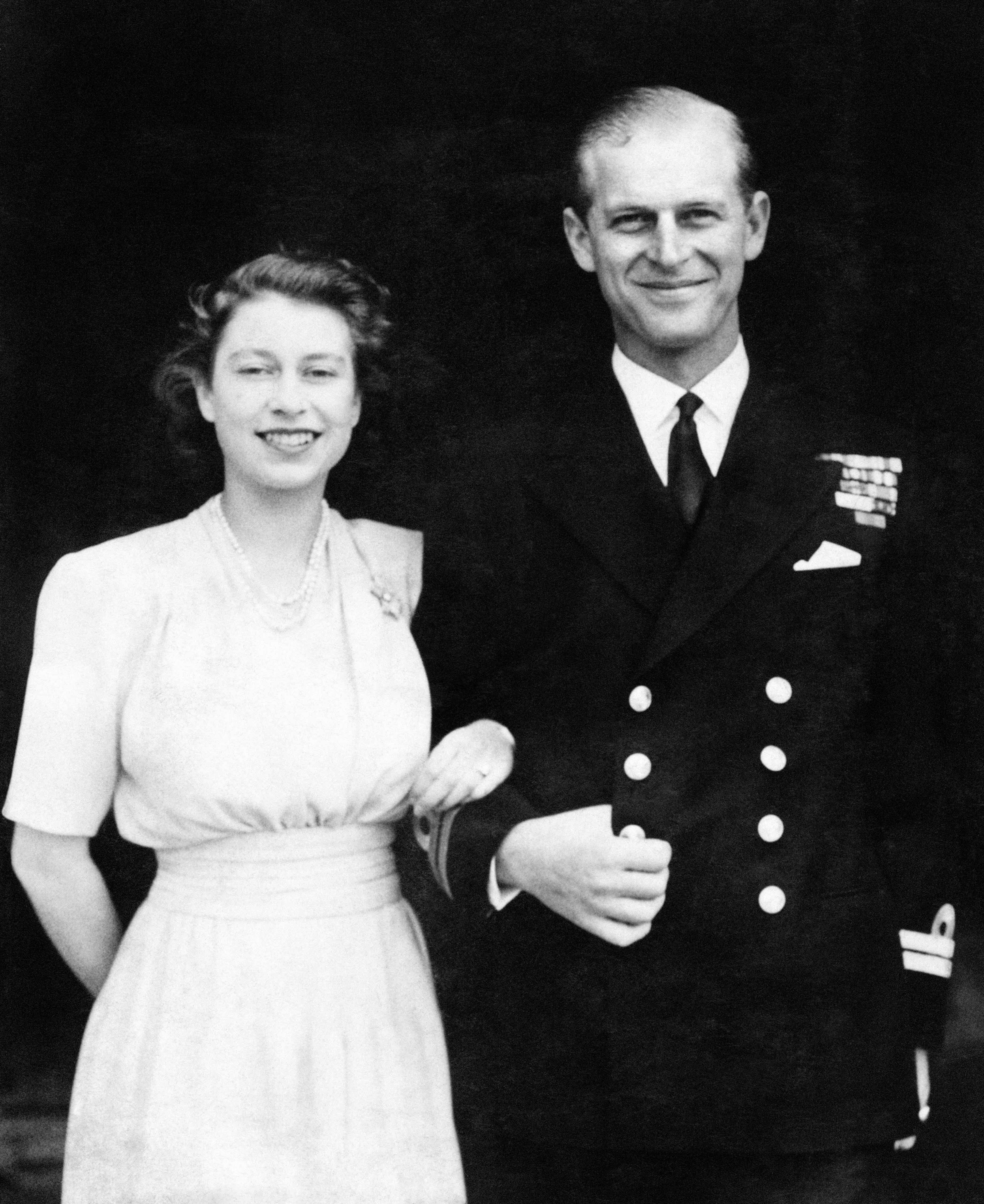 10 July 1947: Princess Elizabeth and Lieut. Philip Mountbatten, whose engagement was announced, pose for their first engagement pictures at Buckingham Palace
