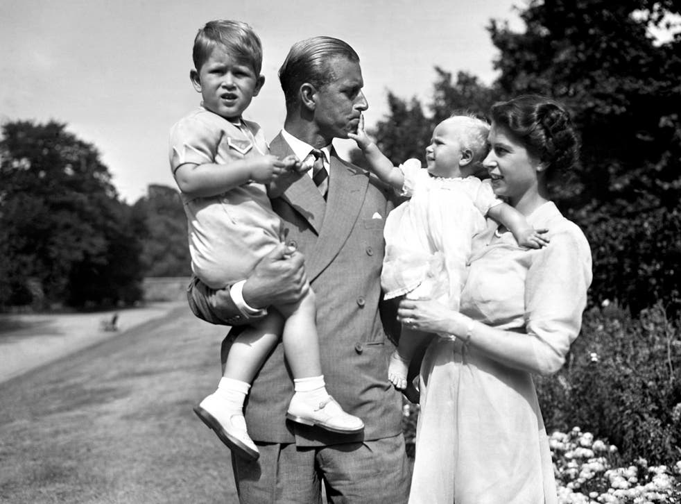<p>Princess Anne in the arms of her mother as the Duke of Edinburgh holds Prince Charles</p>