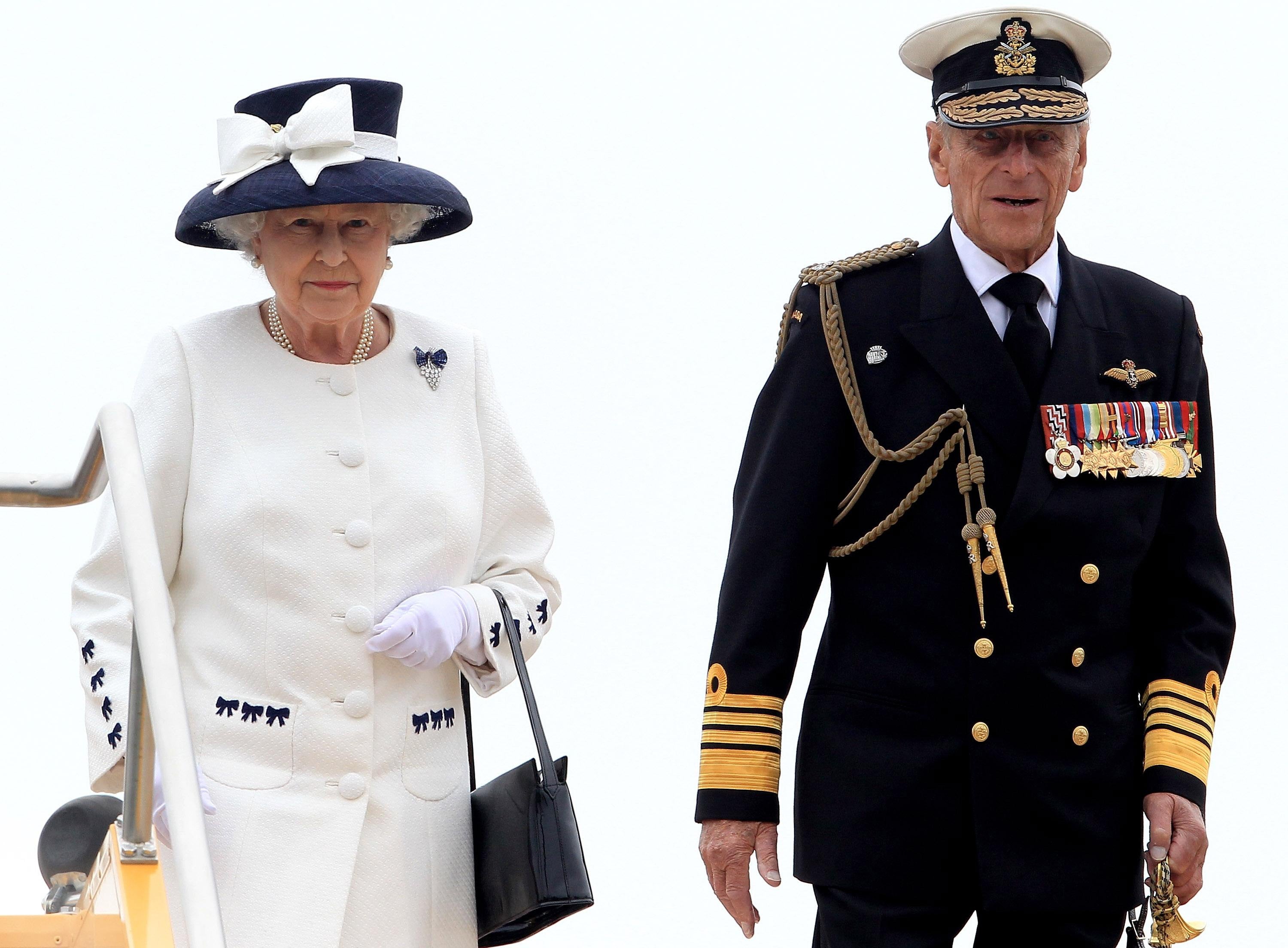 Queen Elizabeth II and the Duke of Edinburgh leave HMCS St John's after a Naval review to mark the 100th anniversary of the Canadian Navy, in the waters off Halifax in Nova Scotia, Canada.