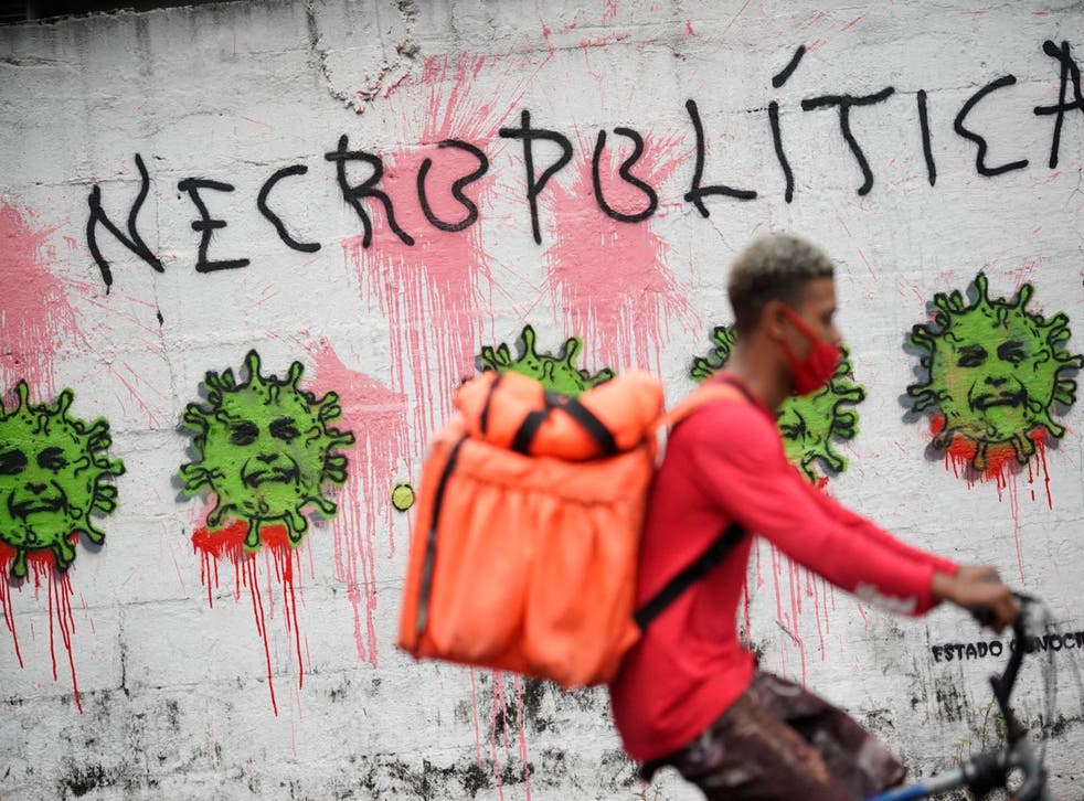 <p>Graffiti showing Jair Bolsonaro’s face - the president is under mounting pressure for Brazil’s high Covid death toll</p>