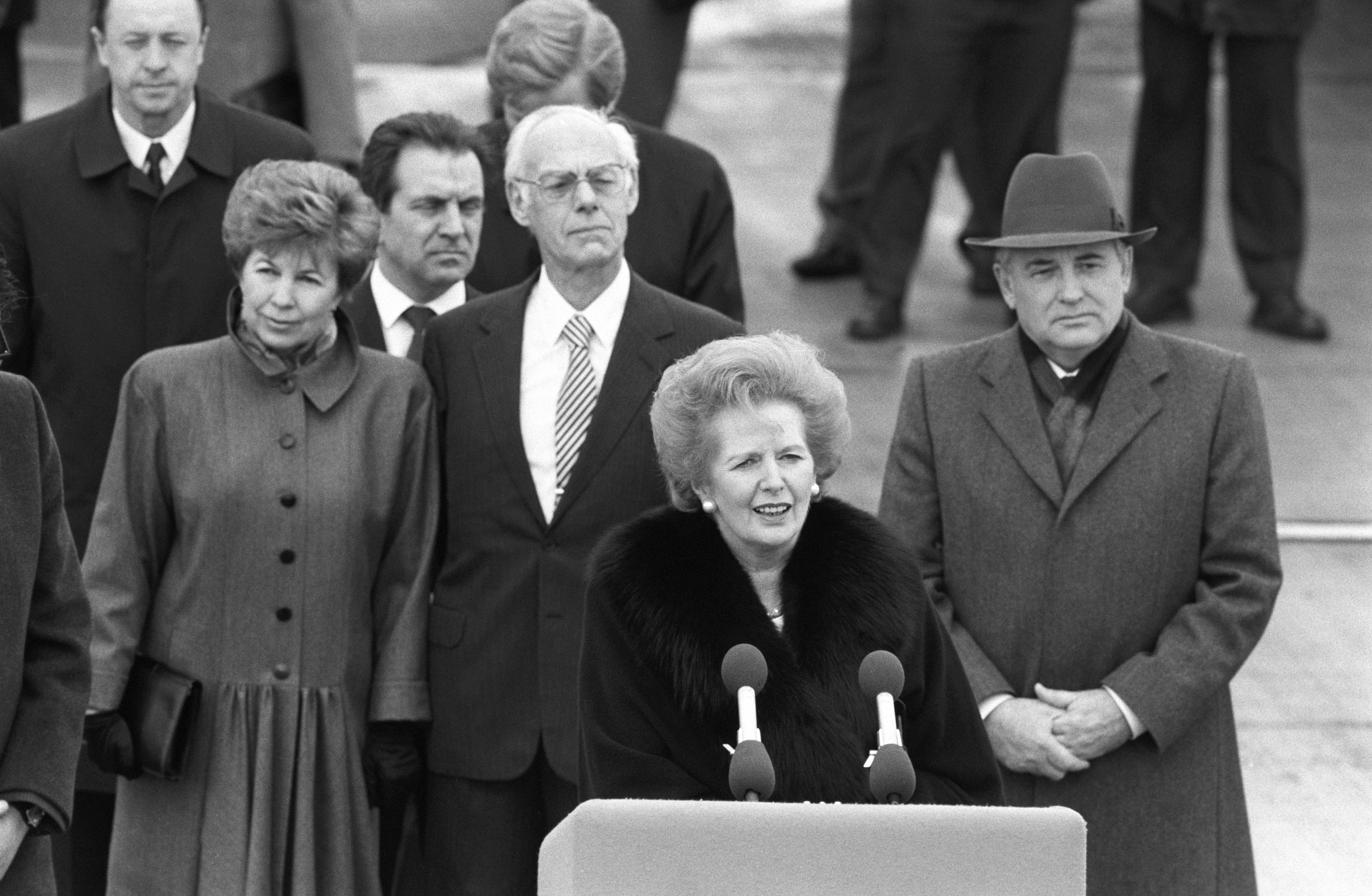 Margaret Thatcher speaks as Soviet president Mikhail Gorbachev (right) and his wife Raisa (left) look on at the end of a state visit to Britain on April 07, 1989