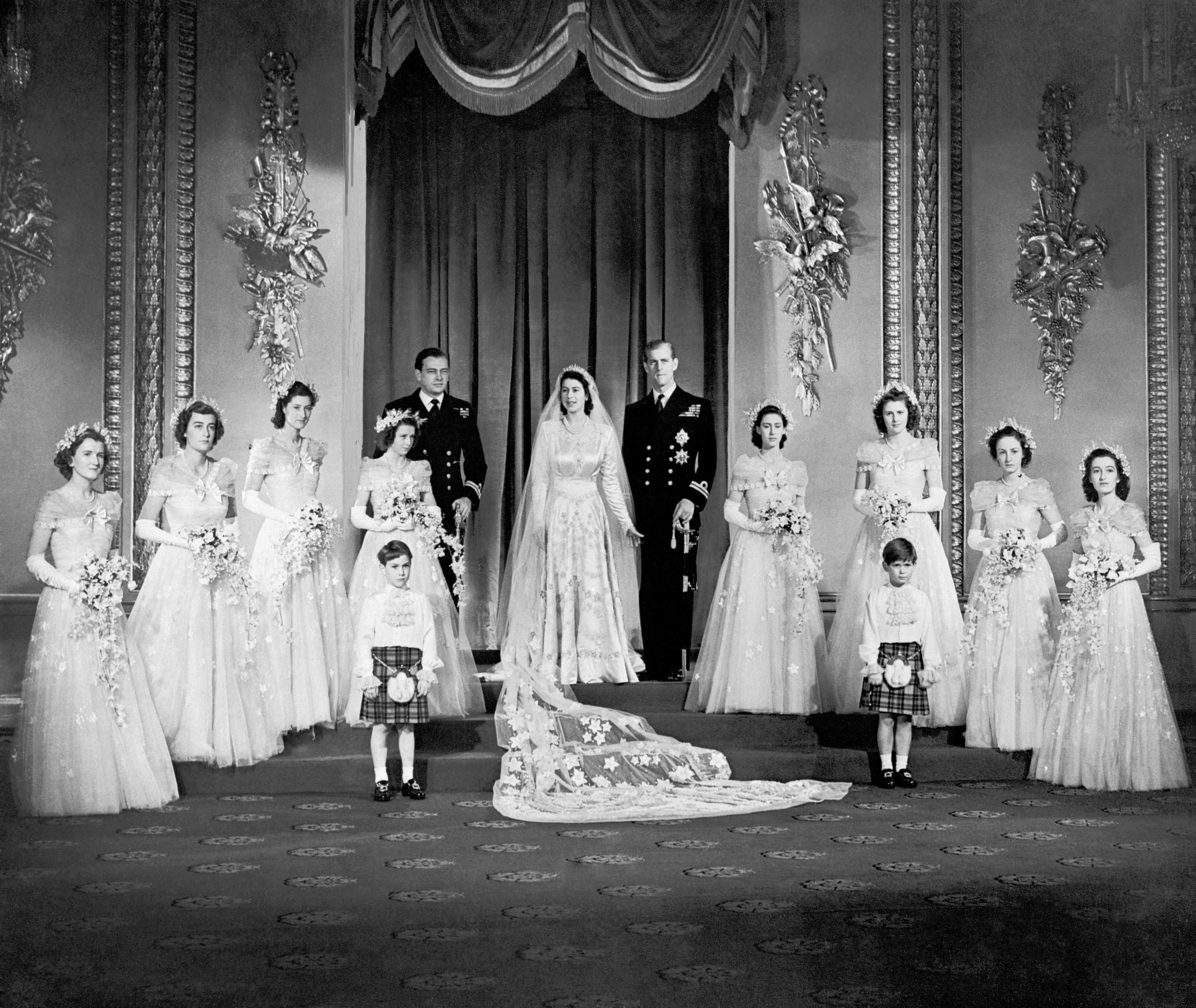 Princess Elizabeth and the Duke of Edinburgh with their eight bridesmaids in the Throne Room at Buckingham Palace on their wedding day
