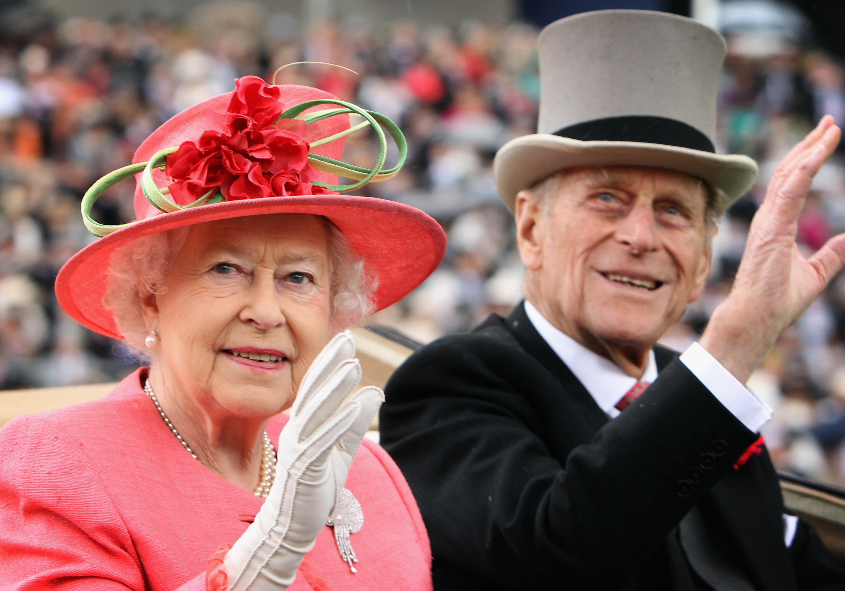 Queen Elizabeth ll and Prince Philip arrive in an open carriage on Ladies Day at Royal Ascot on June 16, 2011
