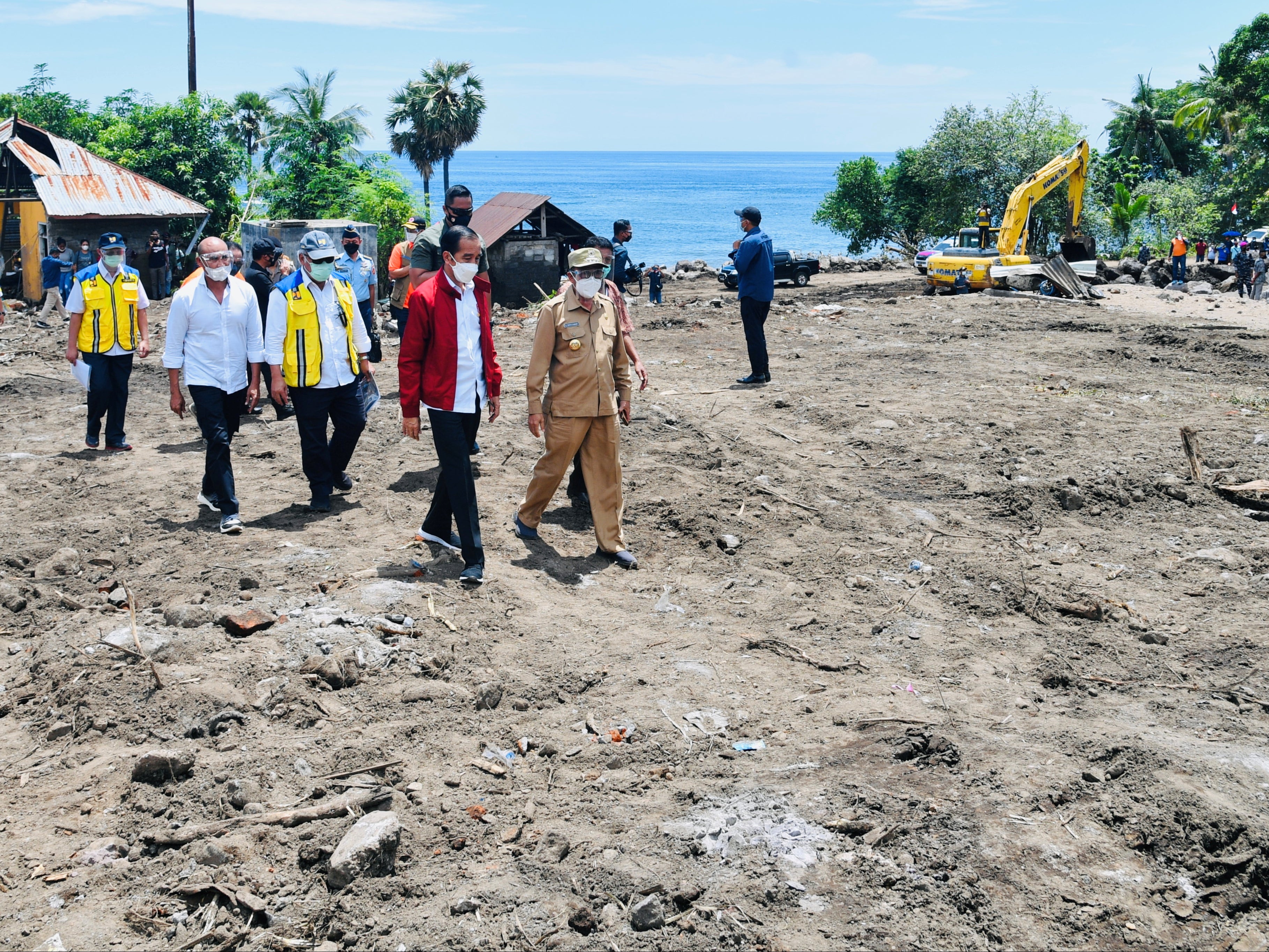 Indonesian President Joko Widodo visits an area affected by flash floods triggered by a tropical cyclone Seroja