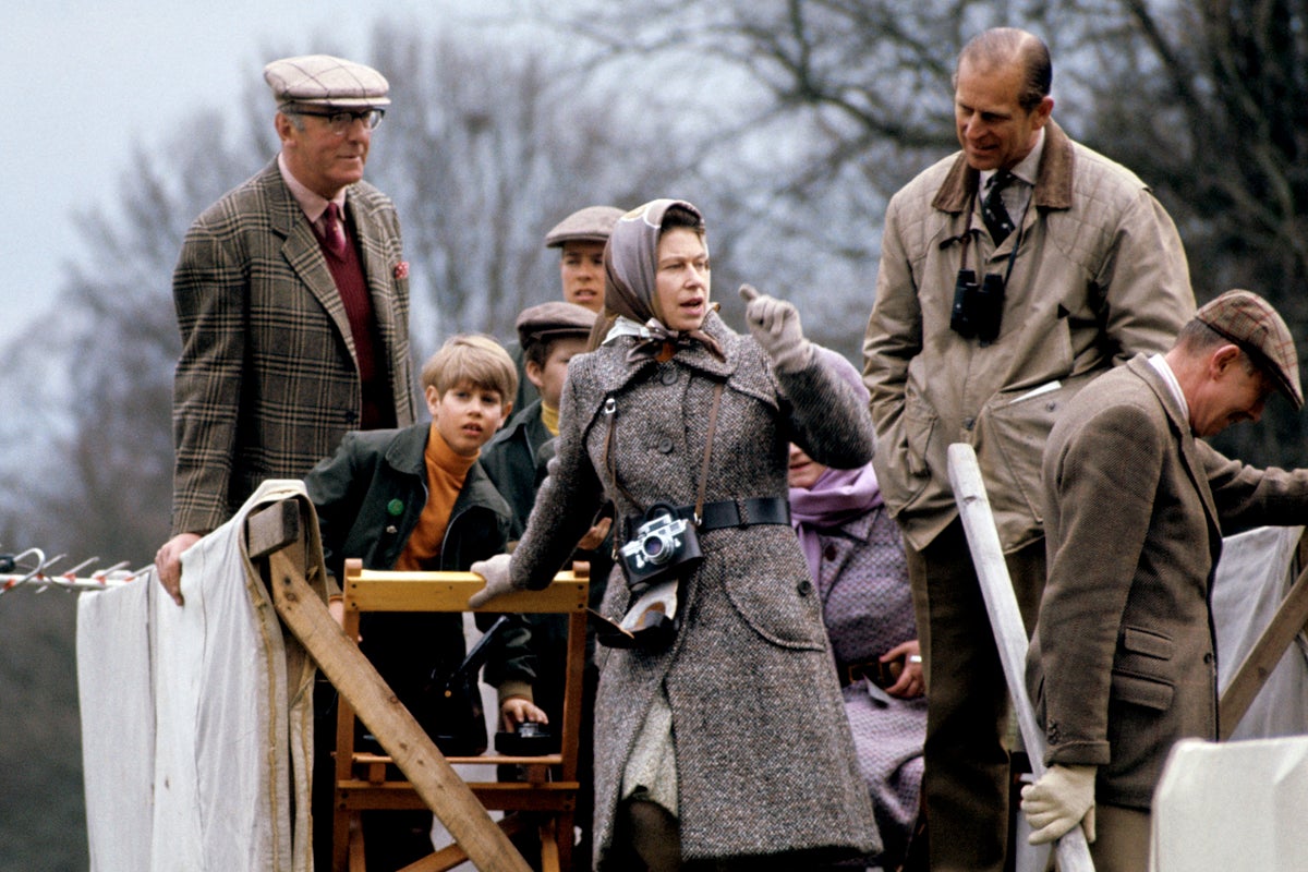 The Duke of Beaufort, Prince Edward, Viscount Linley, The Queen and Prince Philip watch cross-country from a farmcart at the Badminton Horse Trials, 1973.