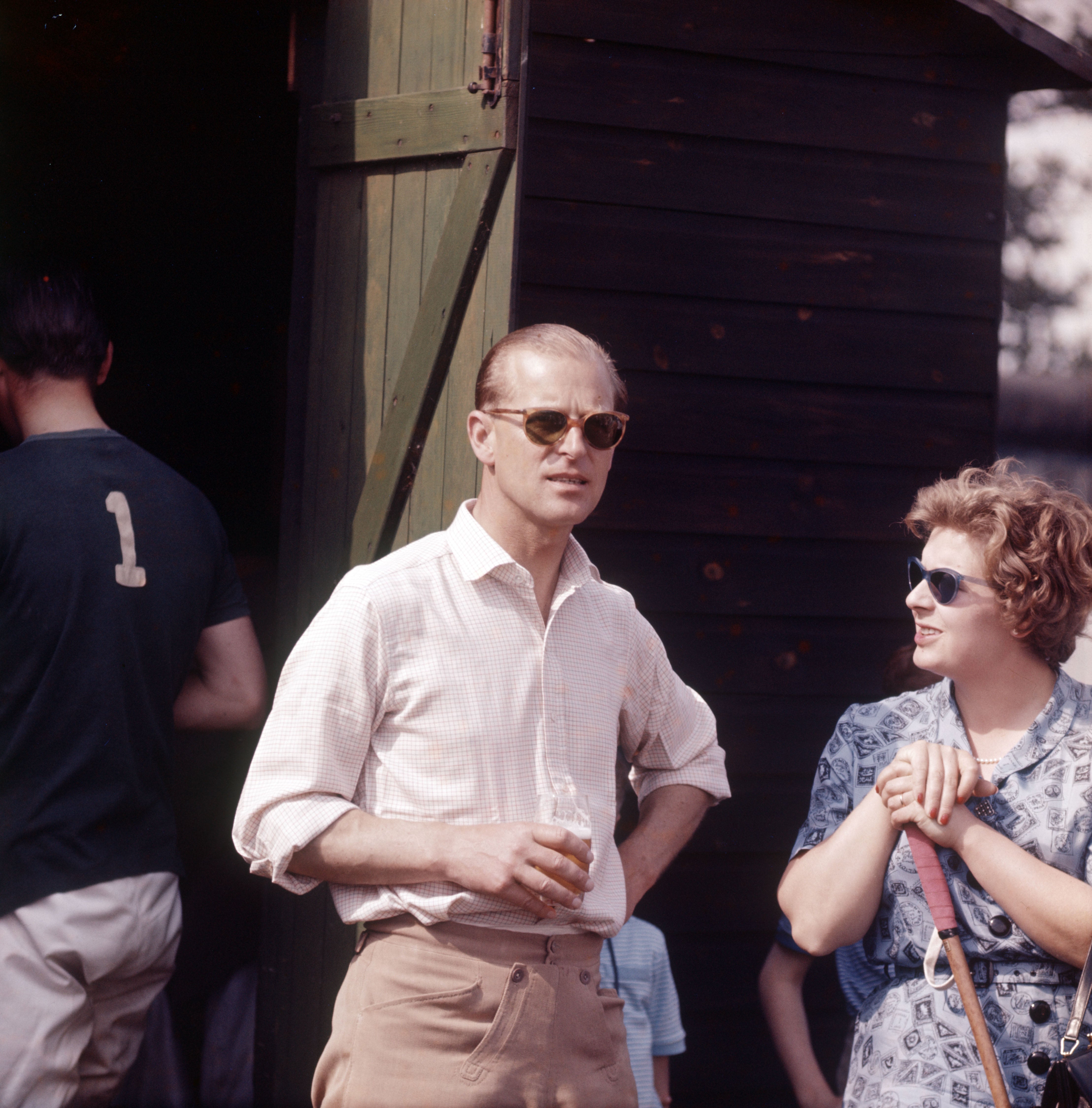 Prince Philip taking a beer during the chukas whilst umpiring a polo match at Ham Common, Richmond, 1961.