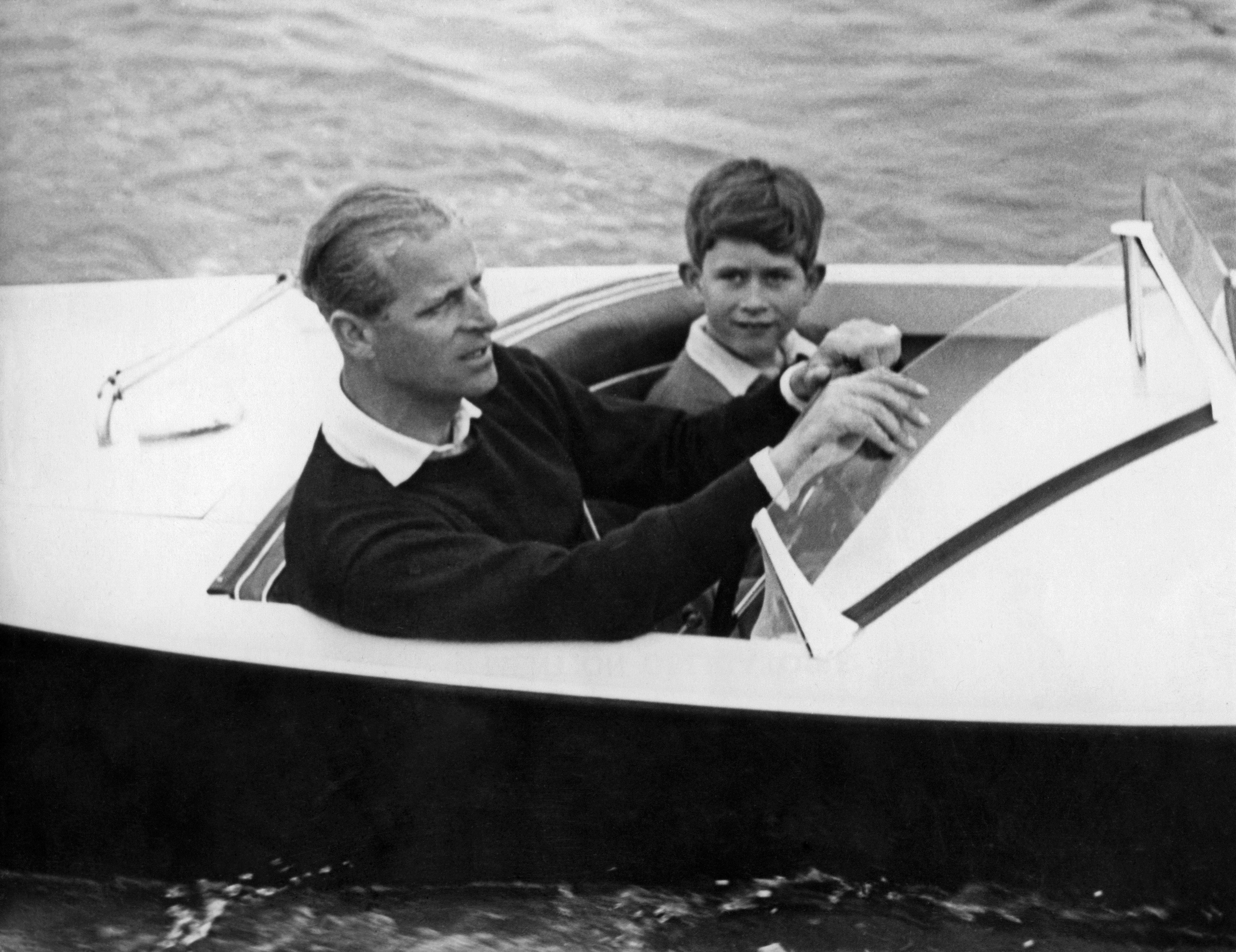 Prince Charles of Wales with his father Prince Philip of Edinburgh on board a boat, 1955