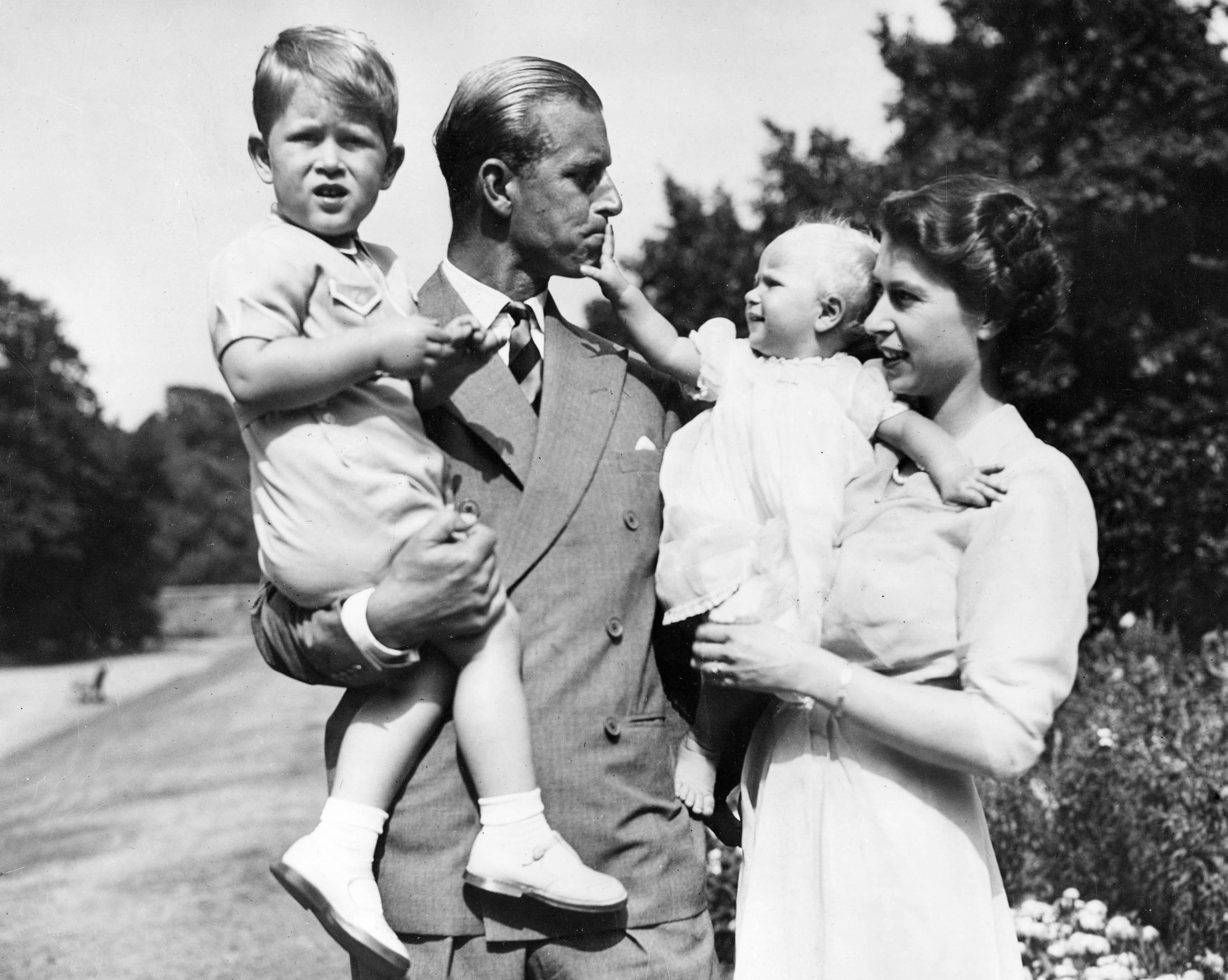 The then-Princess Elizabeth in the garden of Clarence House with Philip and their children Prince Charles and Princess Anne in 1951.