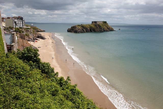 Tenby beach and island, where police say a man was saved after jumping into the sea