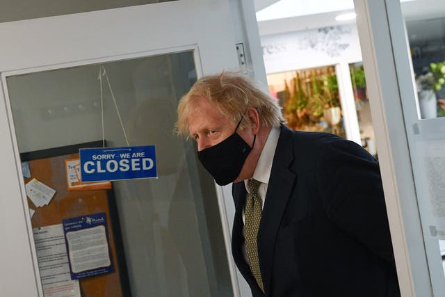 <p>Boris Johnson visits businesses in Truro, England, ahead of the relaxation of restrictions on 12 April</p>