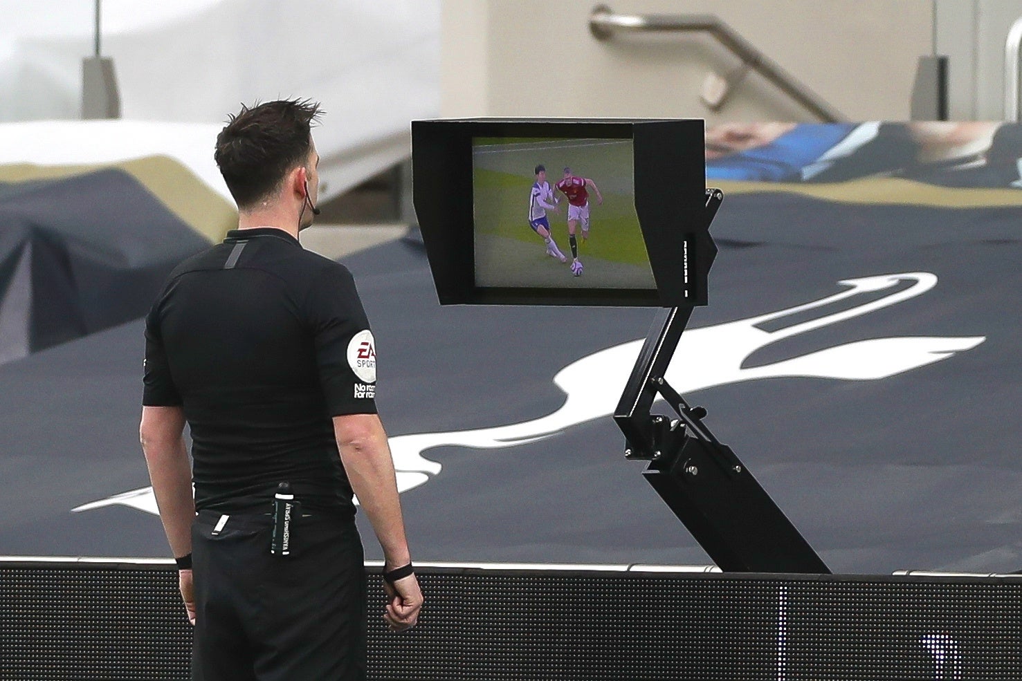 Chris Kavanagh looks at the incident on his pitchside monitor