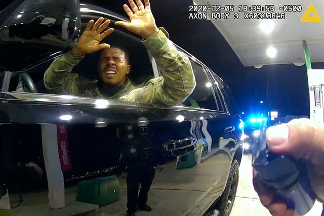 <p>US Army 2nd Lieutenant Caron Nazario reacts as he holds up his hands after being sprayed with a chemical agent by Windsor police officer Joe Gutierrez during a violent traffic stop at a gas station</p>