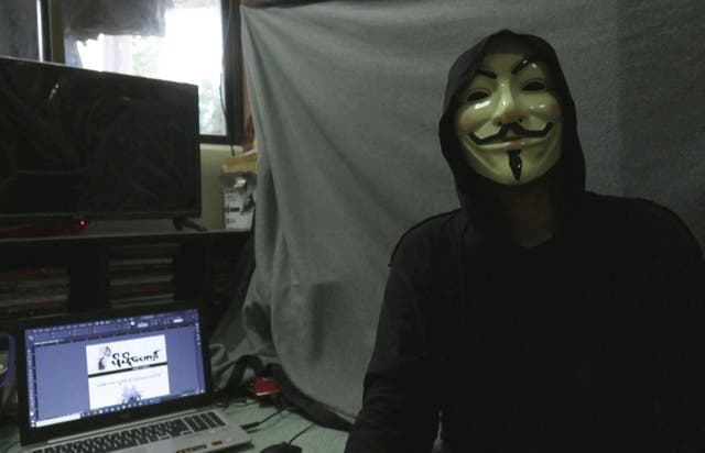 <p>This screengrab provided via AFPTV video footage taken on 10 April, 2021 shows Lynn Thant (an alias) wearing a mask next to a laptop where they are working on an underground newsletter</p>