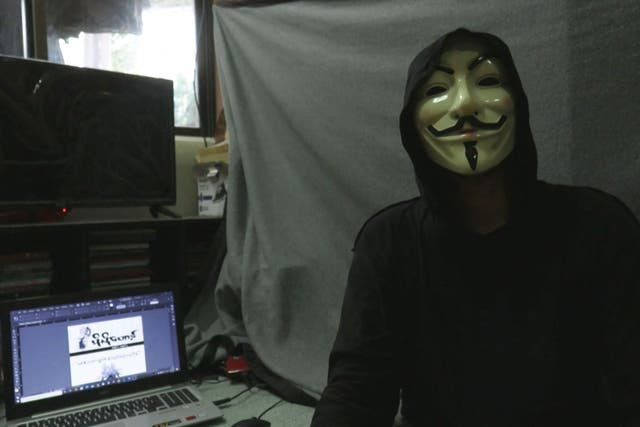 <p>This screengrab provided via AFPTV video footage taken on 10 April, 2021 shows Lynn Thant (an alias) wearing a mask next to a laptop where they are working on an underground newsletter</p>