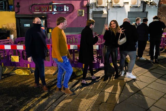 Customers wait outside the Switch bar in Newcastle as it prepares to serve customers after midnight to mark the latest lifting of lockdown measures