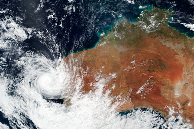 <p>Satellite image released by NASA shows Tropical cyclone Seroja hitting the coast of western Australia on 11 April</p>