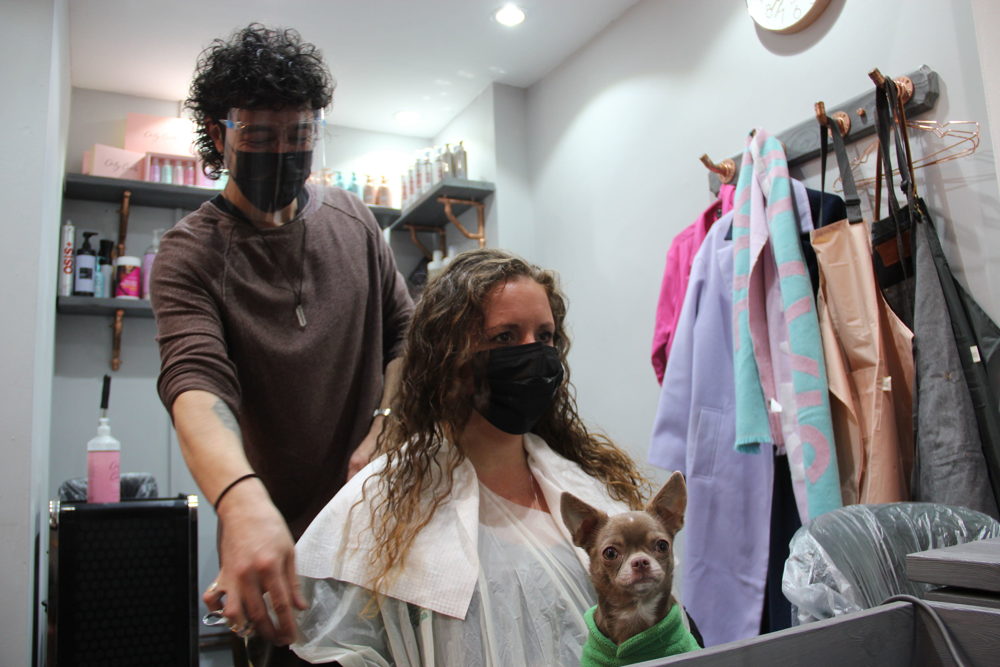 Stylist Danny Law with customer Amy Smith, who is visiting a hairdresser for the first time in more than a year, at the Strand & Lock salon in Birmingham's creative Digbeth quarter
