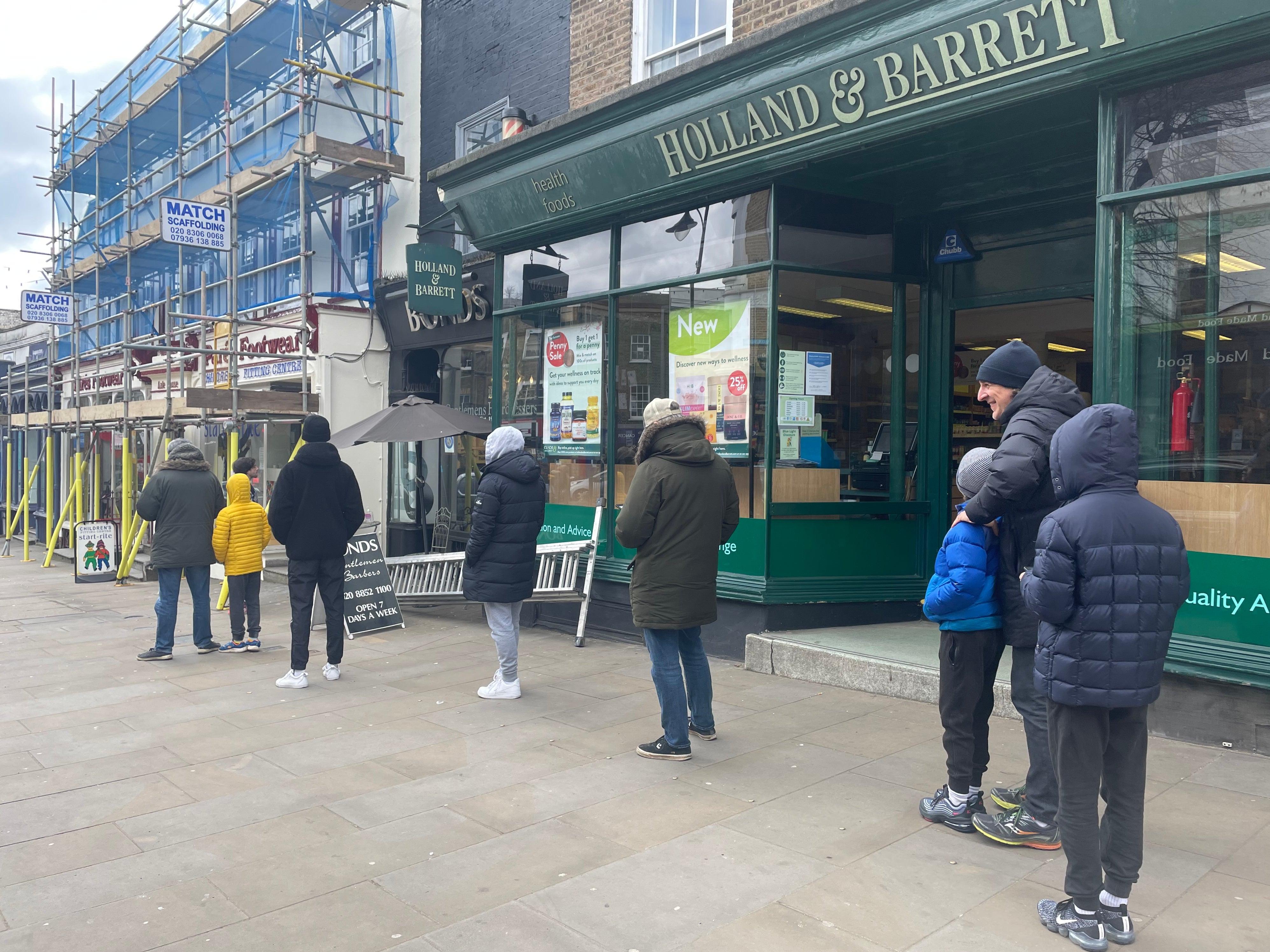Customers wait in a queue outside Bond’s Barber Shop in Blackheath Village as hairdressers are allowed to reopen in England from Monday 12 April 2021