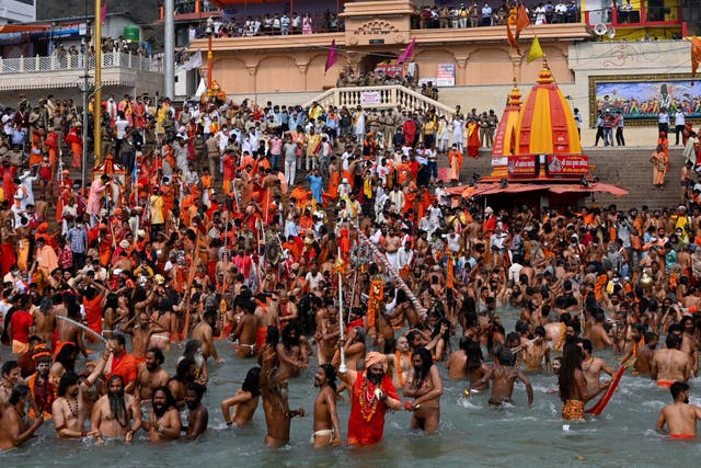 <p>Naga Sadhus (Hindu holy men) take a holy dip in the waters of the Ganges River during the ongoing religious Kumbh Mela festival, in Haridwar, as Covid-19 cases continue to surge in the country </p>