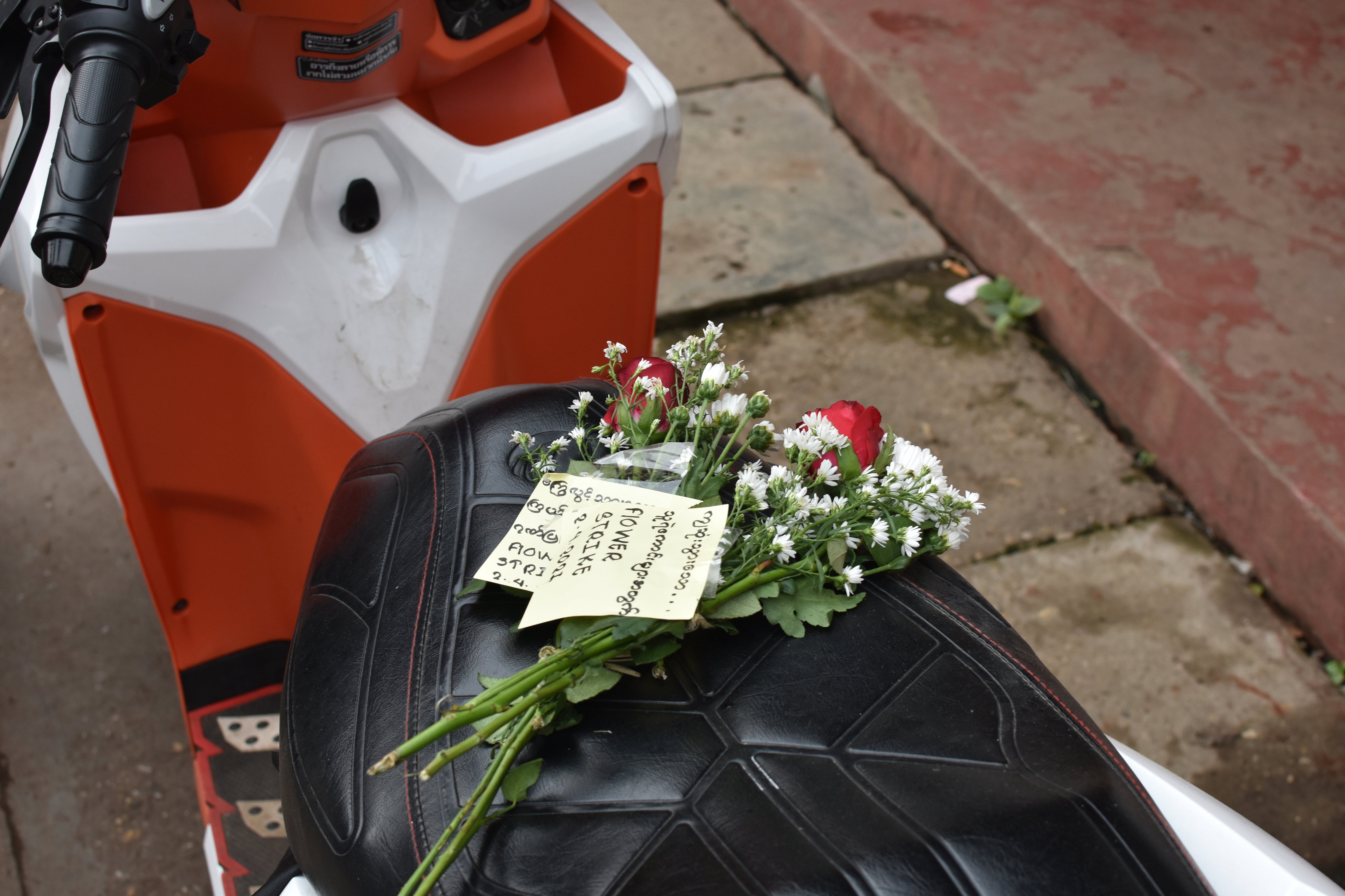 Bouquets of flowers, handed out at Mingaladon Market in Yangon on 2 April, are adorned with sticky notes advertising a "Flower Strike" to remember those killed by security forces