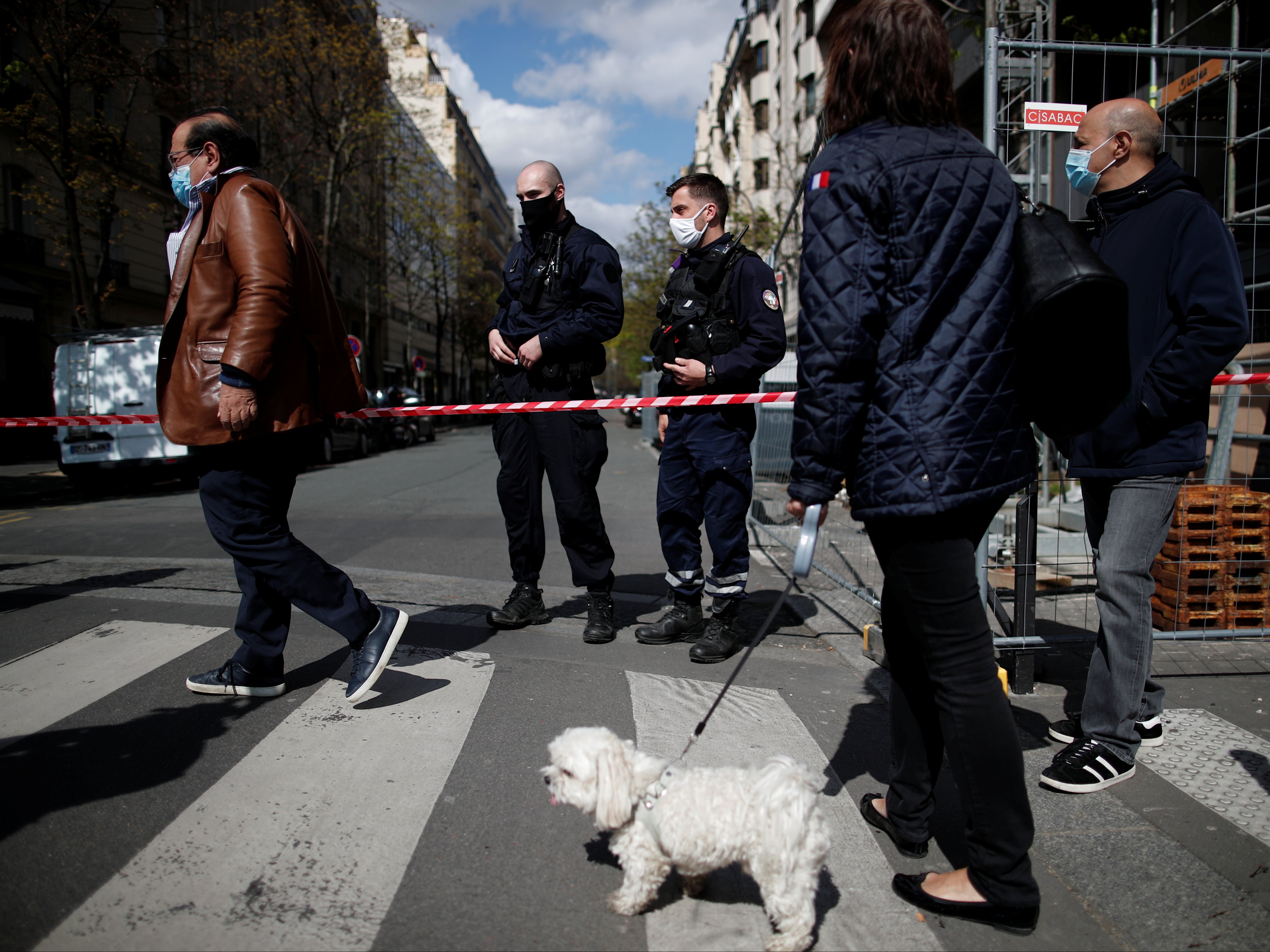 French police secure the area after one person was shot dead and one injured in front of the Henry Dunant hospital in Paris