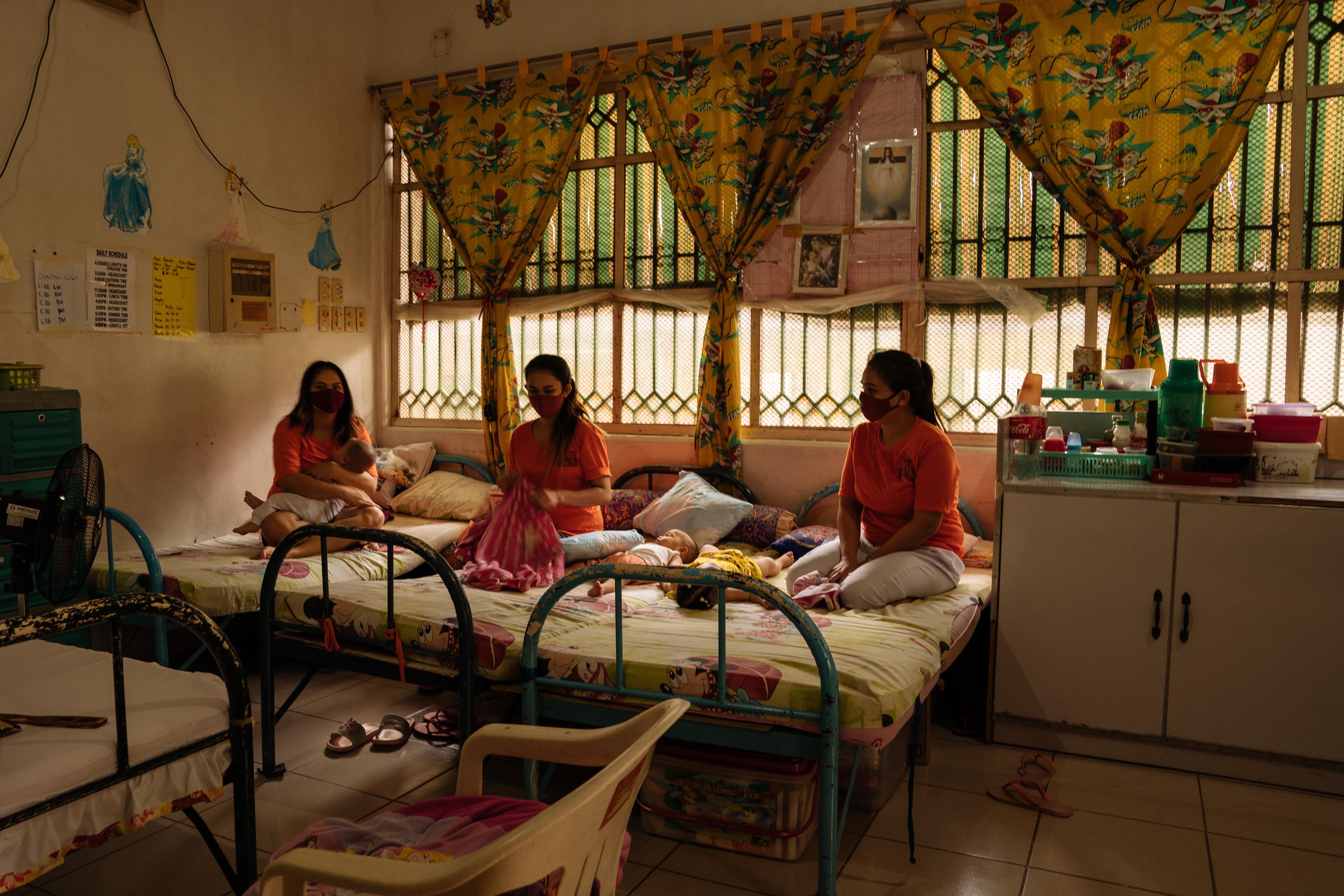 Mothers sit with their babies in the institution’s maternity ward