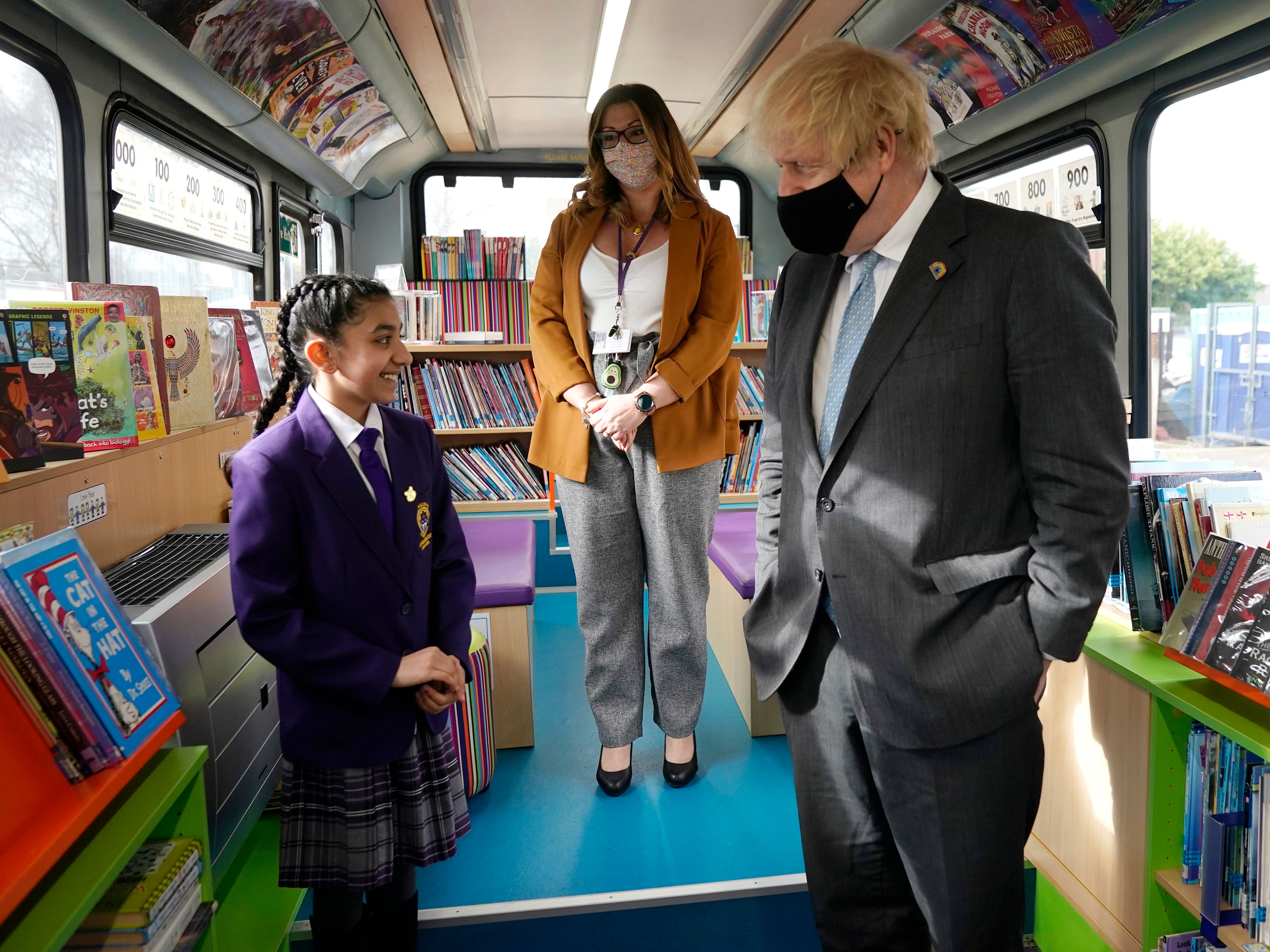 Boris Johnson speaks to a primary school student onboard a bus library during a visit to St Mary’s CE Primary School last month in Stoke-on-Trent