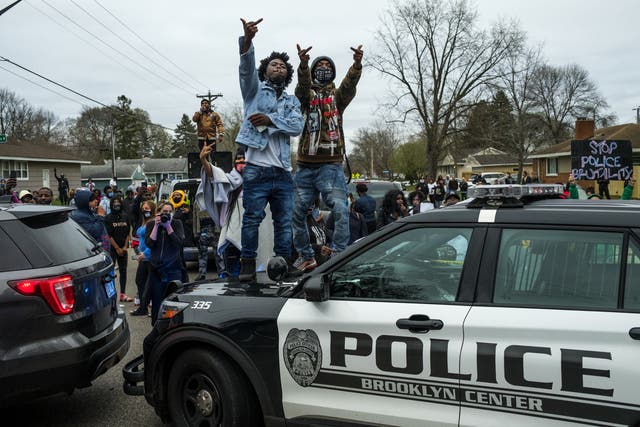 <p>People stand on a police cruiser as protesters take to the streets after Brooklyn Center police shot and killed Daunte Wright during a traffic stop on April 11, 2021 in Brooklyn Center, Minnesota.</p>