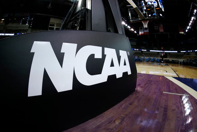 <p>The NCAA logo is seen on the basket stanchion before the game between the Oral Roberts Golden Eagles and the Florida Gators in the second round game of the 2021 NCAA Men's Basketball Tournament at Indiana Farmers Coliseum on March 21, 2021 in Indianapolis, Indiana.</p>