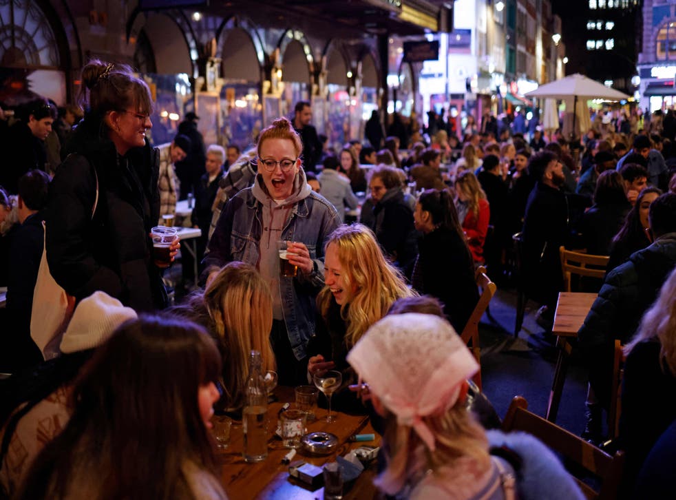 Drinkers outside in Soho, London on Monday night as pubs reopened after lockdown