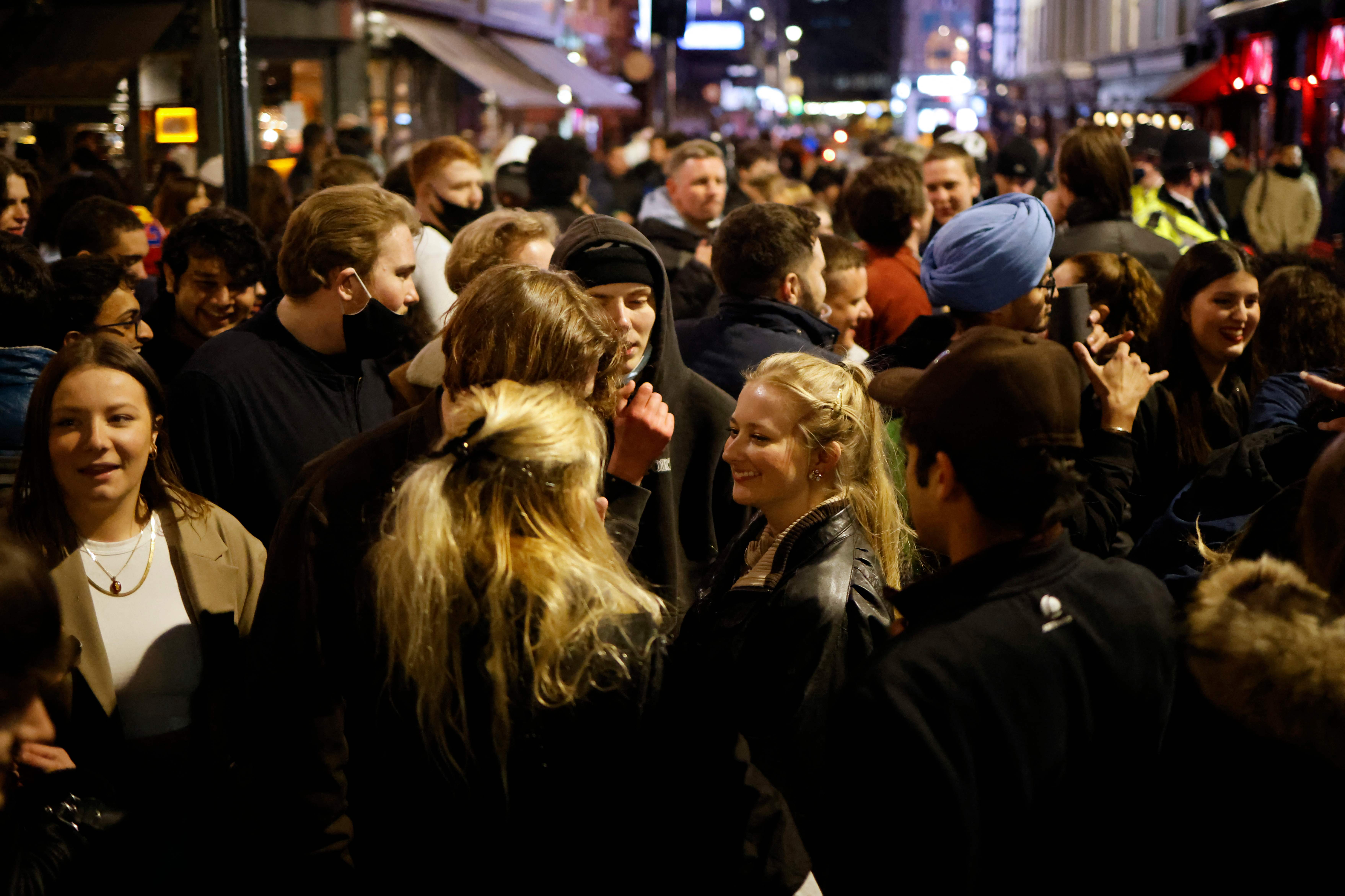 Drinkers in the street in Soho, London on Monday night as pubs reopened after lockdown