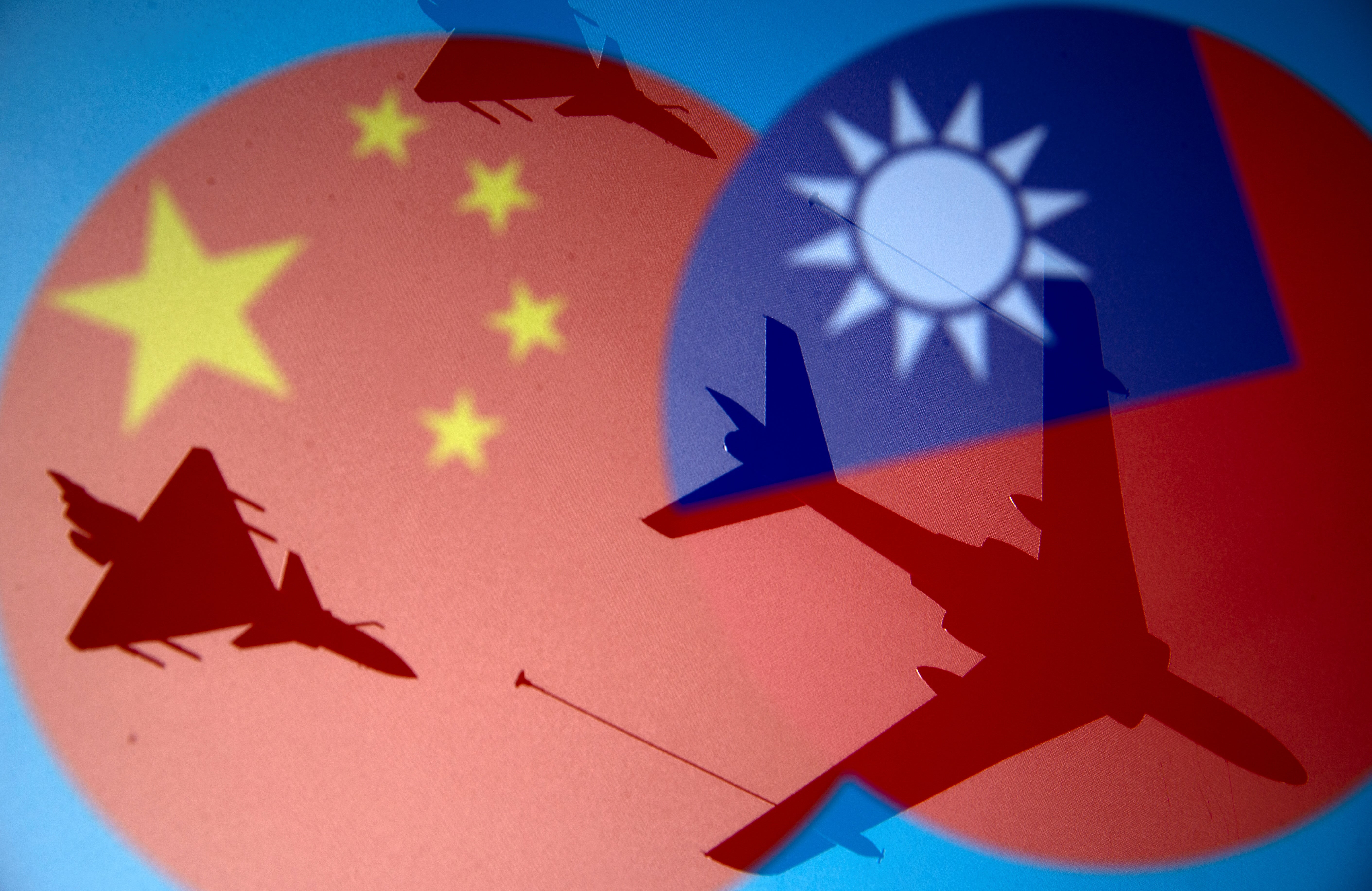 File: Chinese and Taiwanese national flags are displayed alongside military airplanes in this illustration