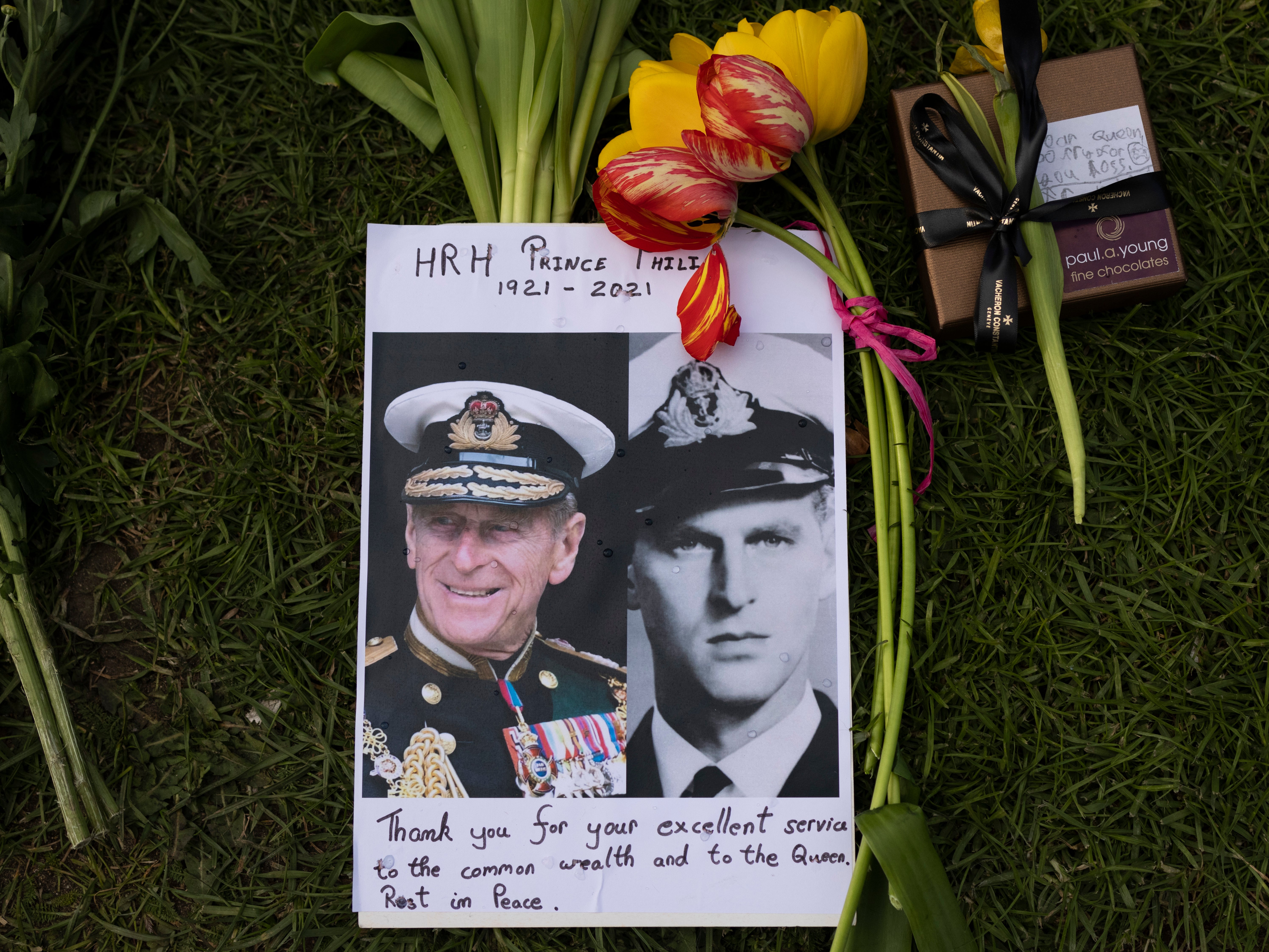 Members of the public leave floral tributes to Prince Philip outside of Windsor Castle