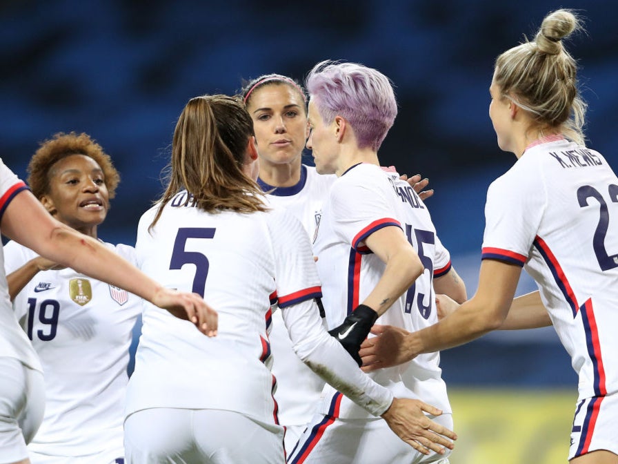 Megan Rapinoe celebrates with teammates after scoring against Sweden