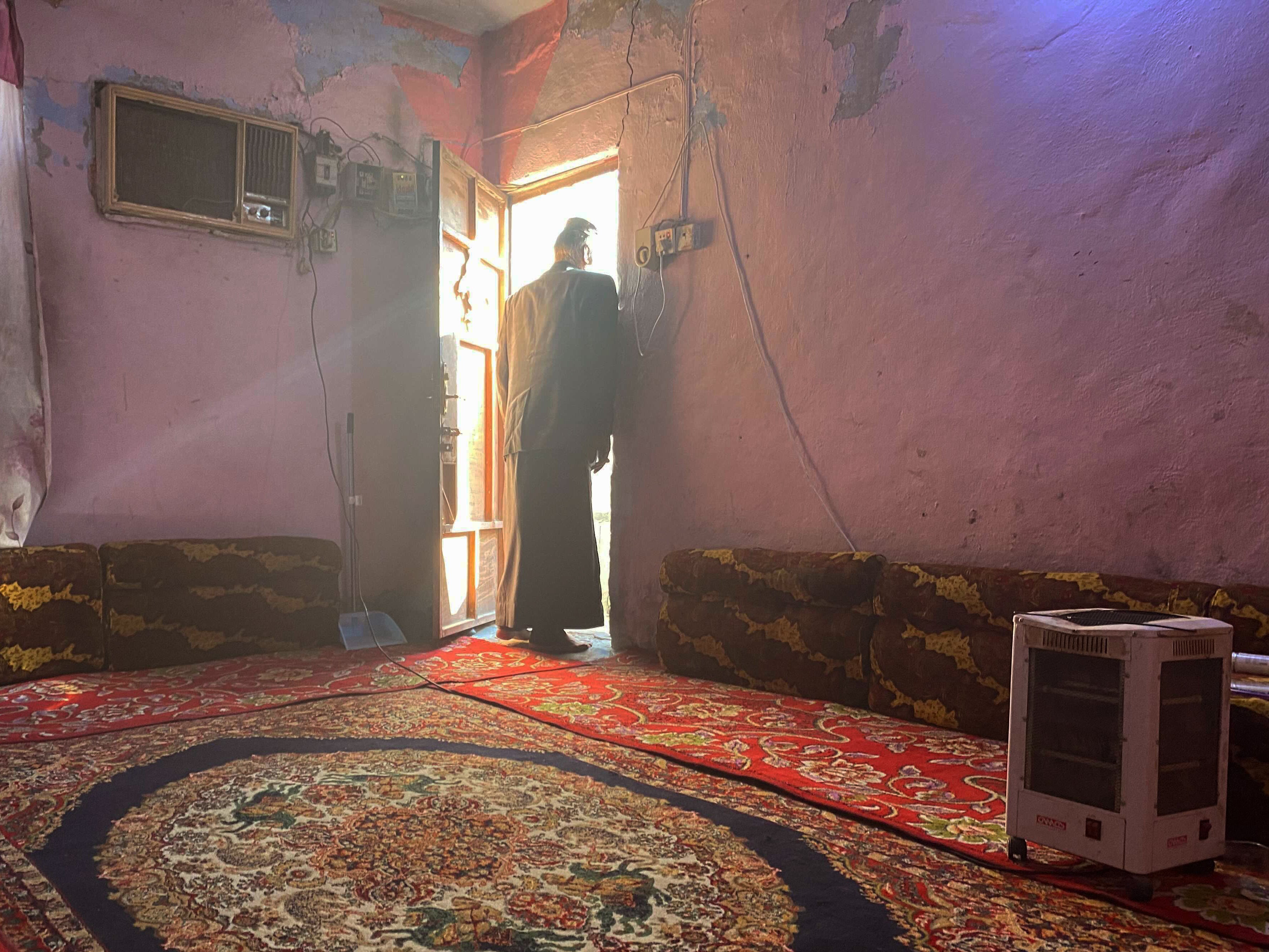 Abdullah, 58, in the door of his cramped family home. He had expected to be able to build a new house on land from the PMF when his brother died as a member of an Iraqi militia