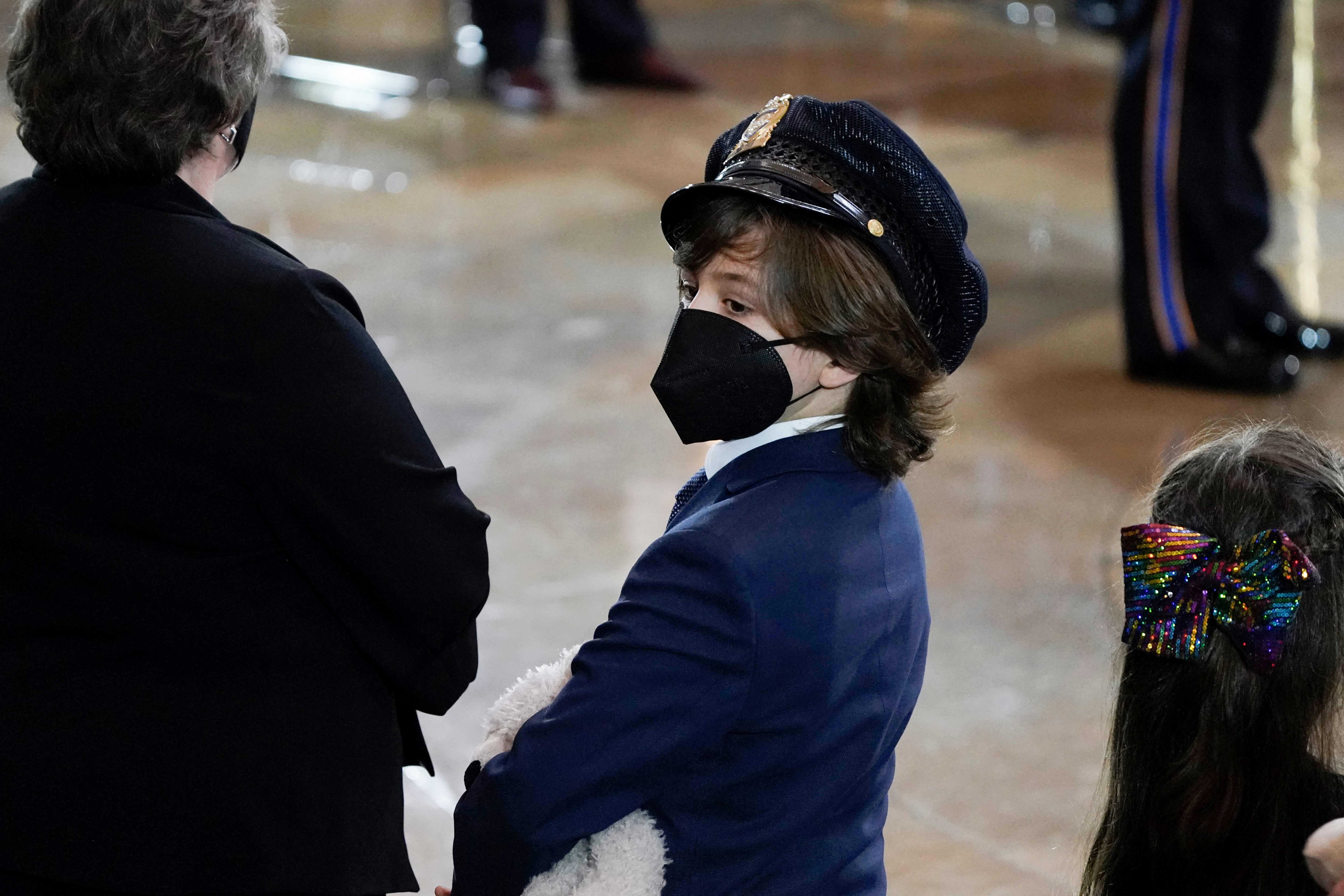 Logan, son of slain U.S. Capitol Police officer William Billy Evans holds a stuffed bear during a ceremony for his father at the Capitol in Washington, DC on April 13, 2021