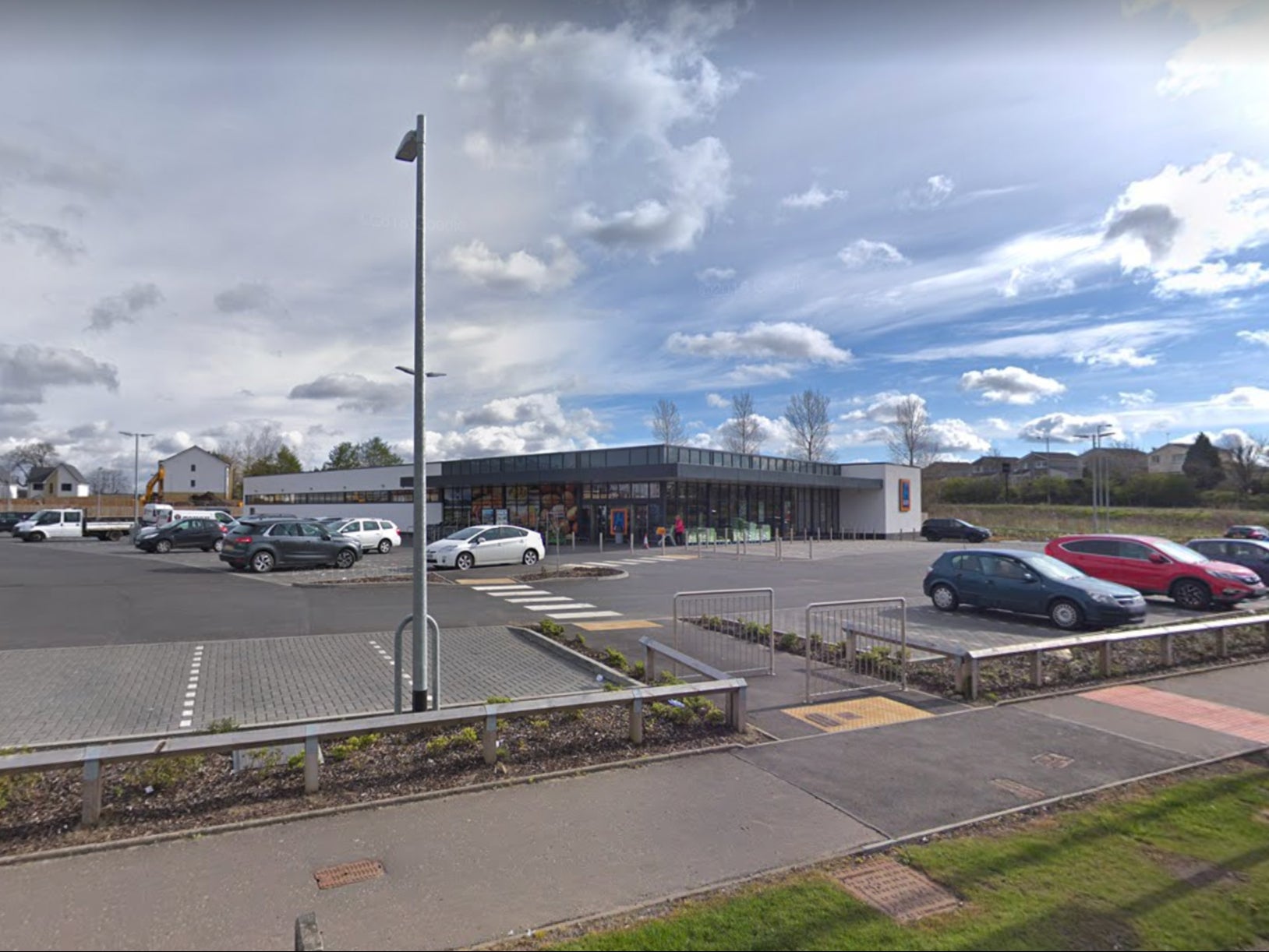 Police gathered outside the Newton Mearns branch of Aldi, seven miles southwest of Glasgow City Centre