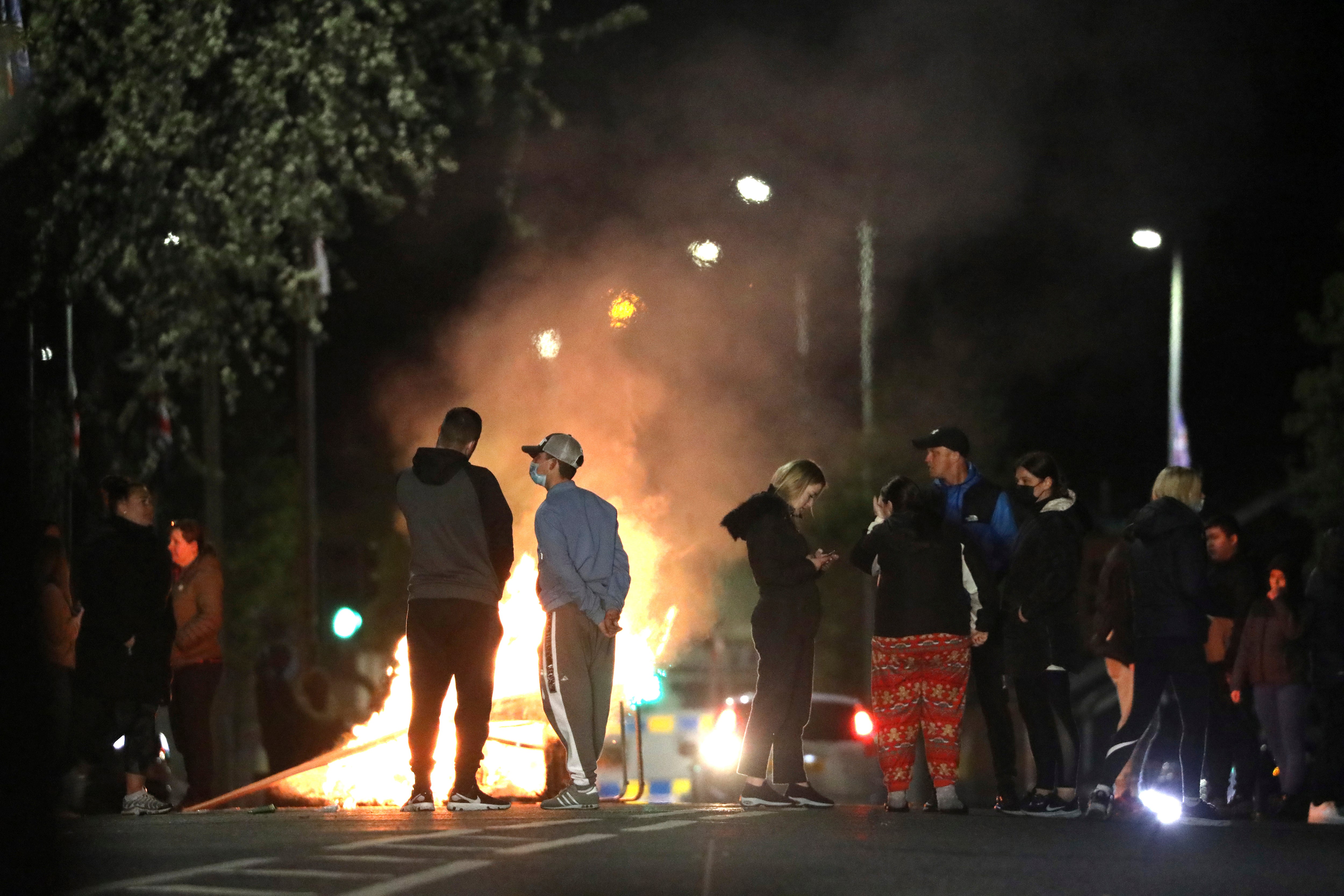 Loyalists block a road during disturbances in North Belfast on Friday