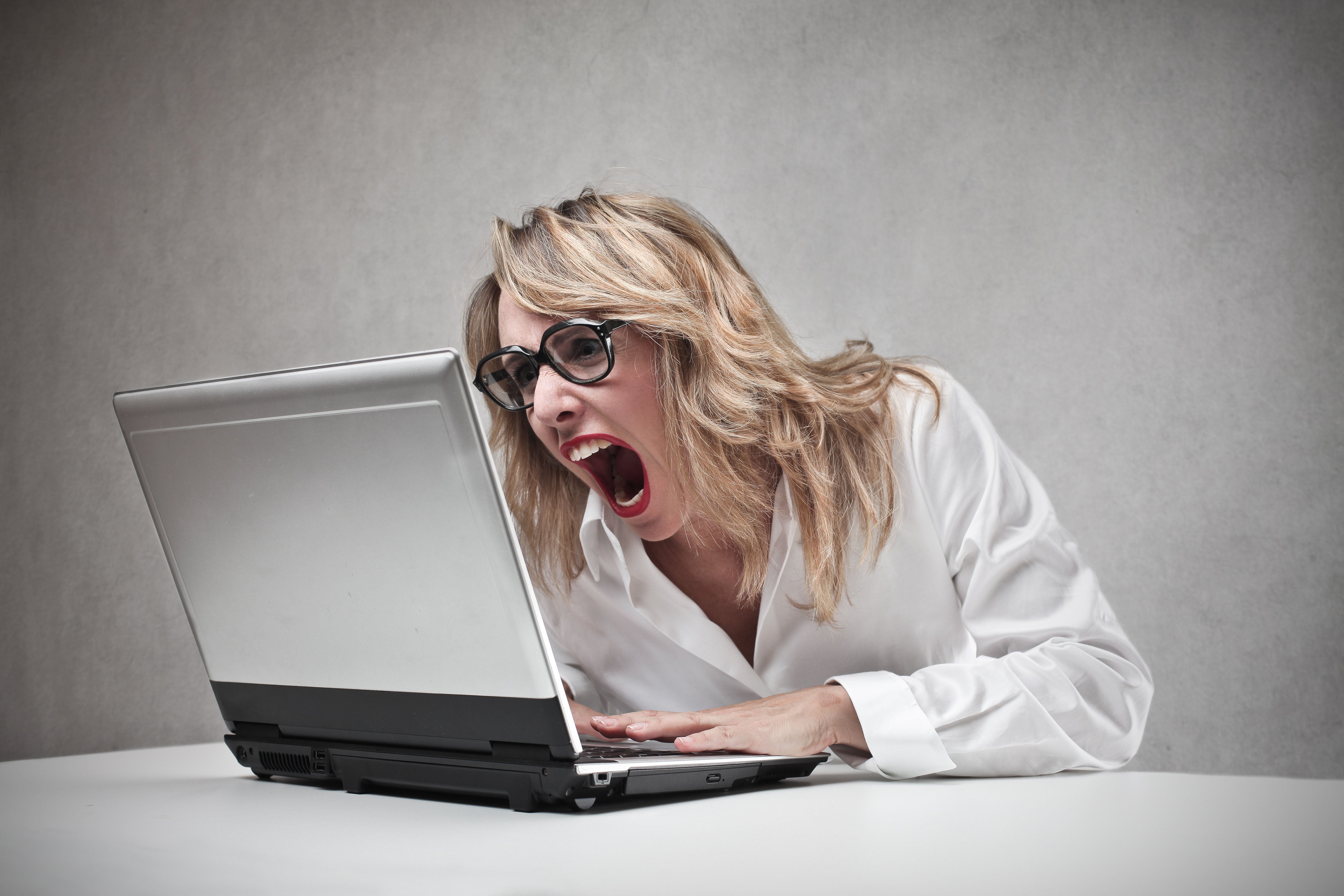 Woman screaming at laptop