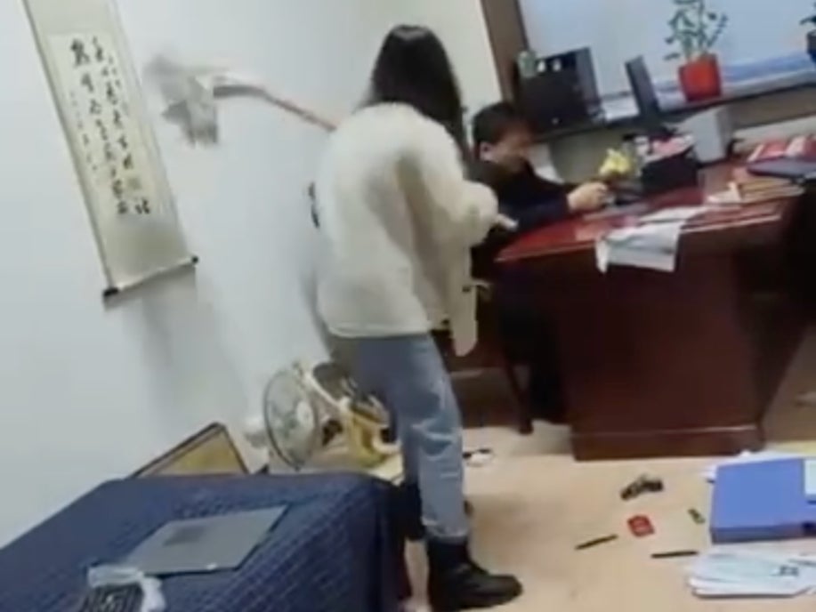 A government office worker in China went viral after she was seen in online video beating her boss with a mop. 